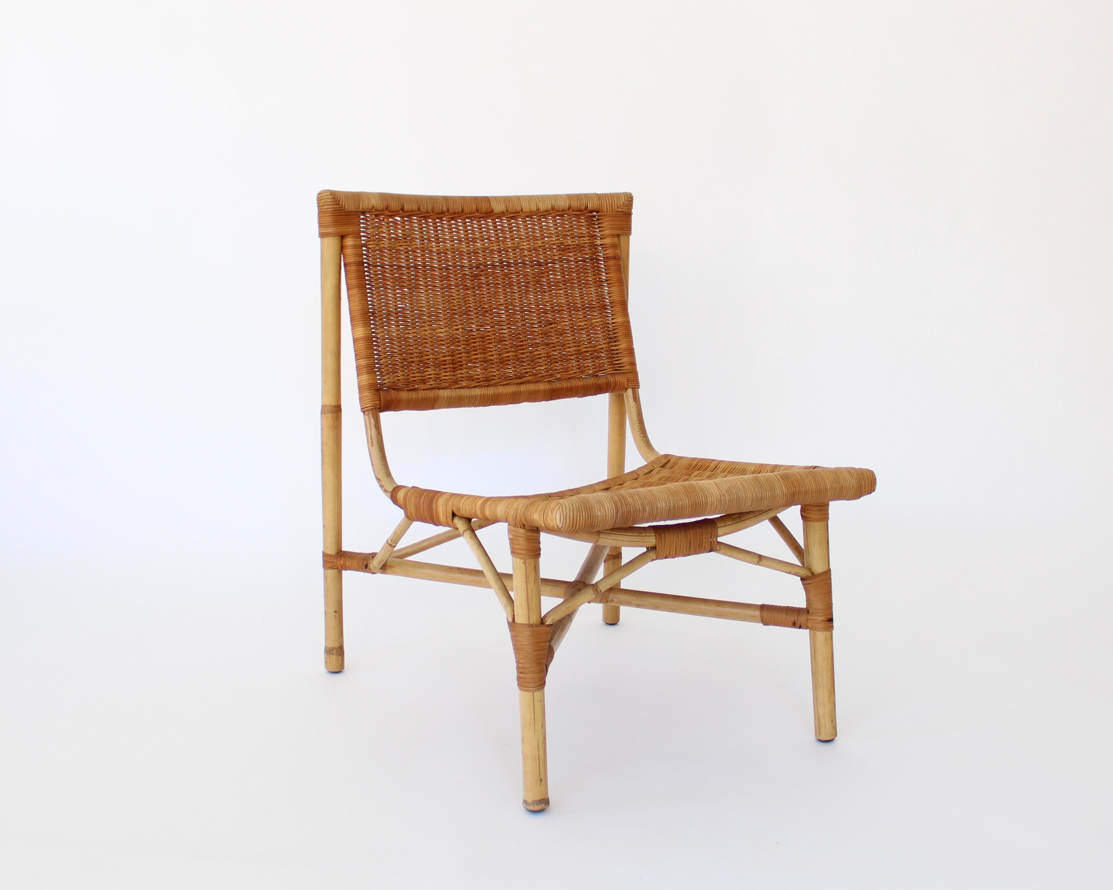 A pair of rattan and bamboo low lounge chairs attributed to French designer Jacques Dumond, France, c 1950.
Excellent condition with no breaks or issues with the rattan or bamboo.
Overall size: 20
