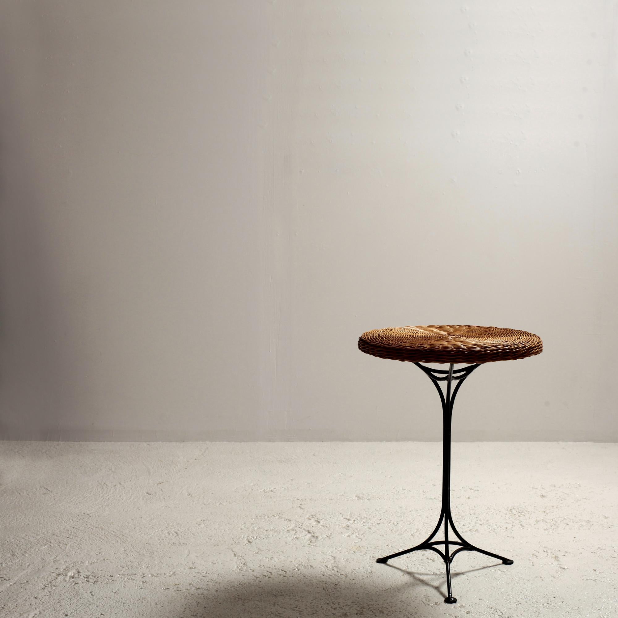 An adorable Gueridon or side table. Original rattan circular top. Iron tripod stand with outstanding shape and original black paint showing some signs of wear and age. Circa: 1950s, Origin: France.
Condition: In very good vintage condition.
In the