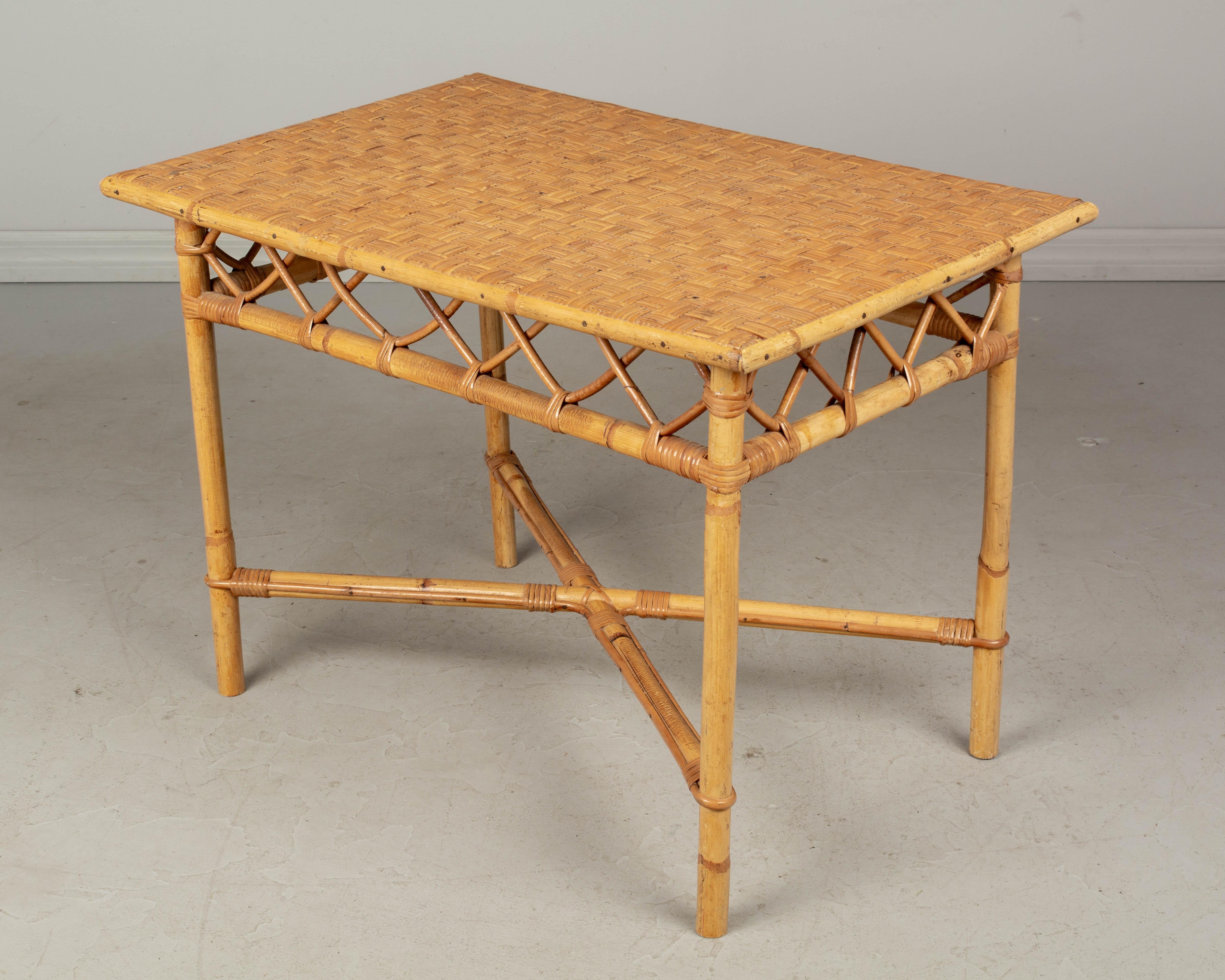 A mid century French rattan child's desk and chair. This small chair and matching desk are sturdy and in good condition. The desk has a woven rattan surface and may be used as a coffee table or side table.
Measures: Table: 30.5