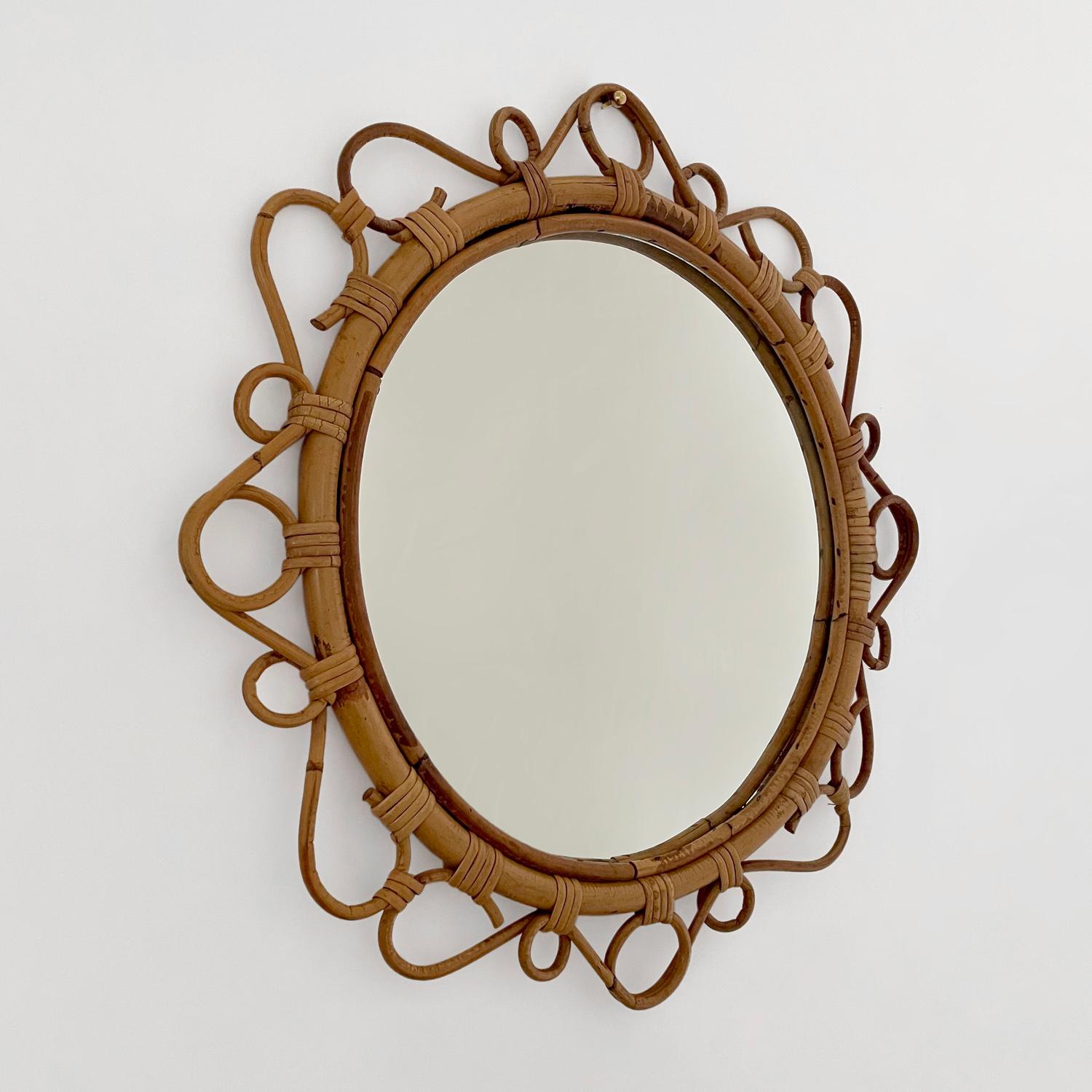 French rattan circular wall mirror
France, circa 1950’s
Circular mirror frame is comprised of intricately coiled rattan
Whimsical statement piece
Natural color variations
Original mirror may have light surface markings
Patina from age and use