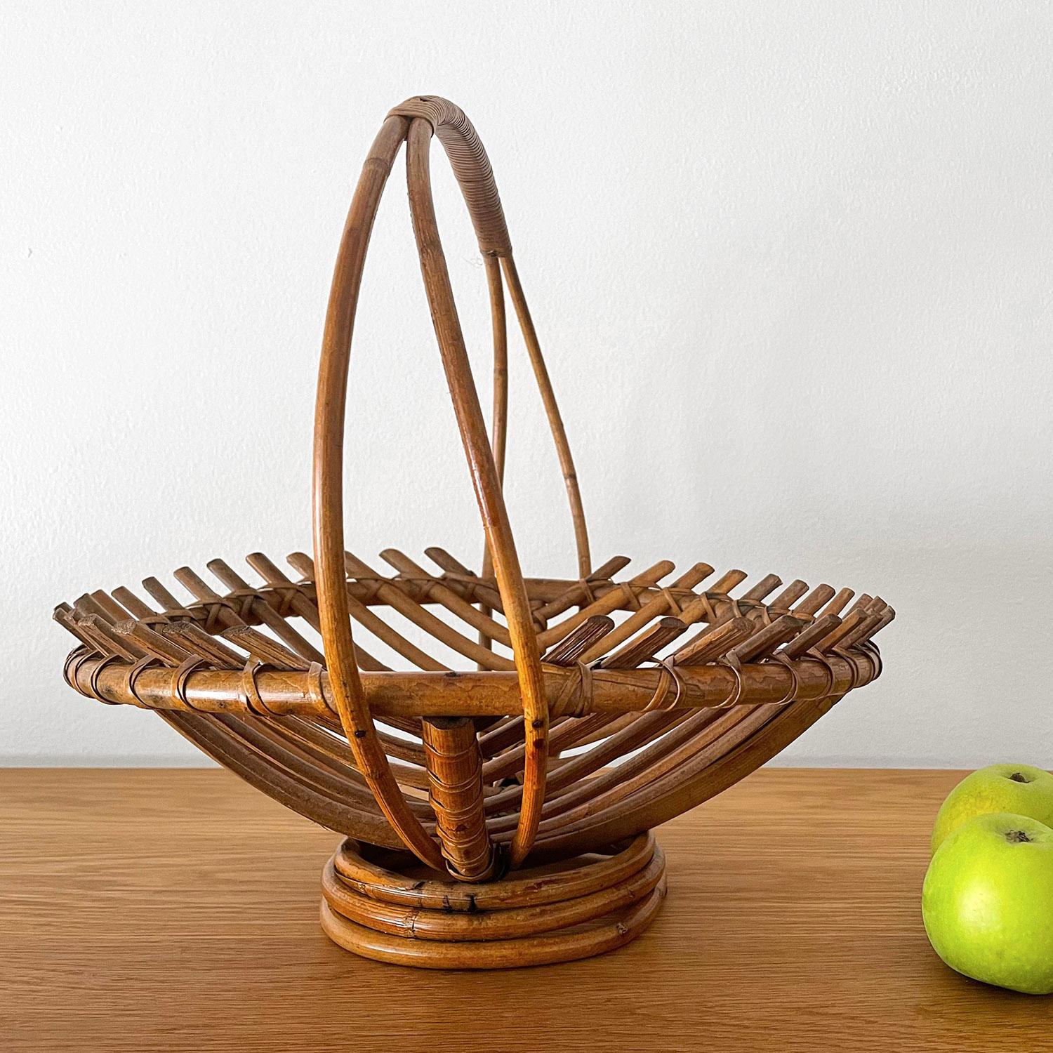 French rattan fruit basket
Sculptural bent reed with delicate curved handle 
Platform base
