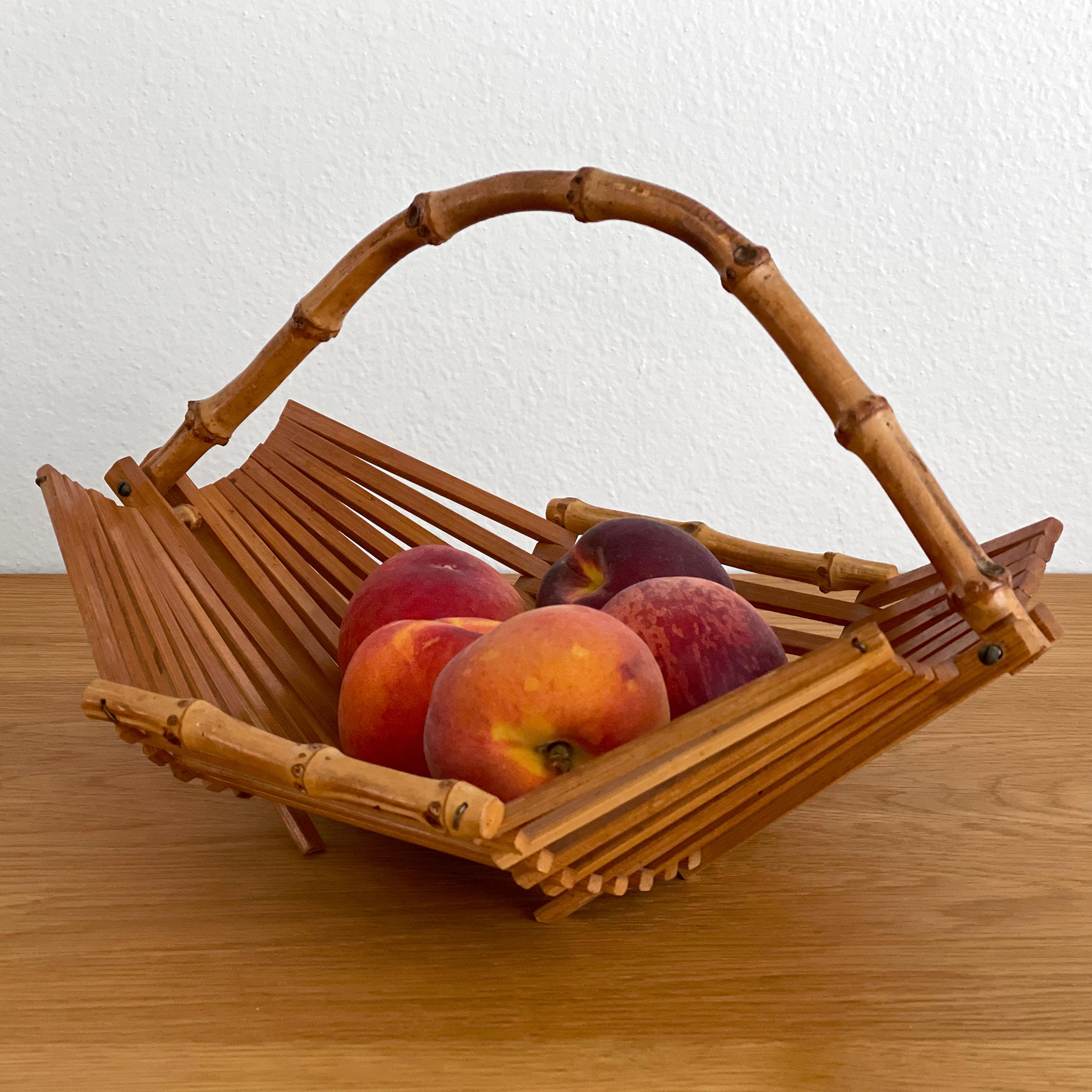 French bamboo fruit basket
France, circa 1950s
Sculptural lines with curved bamboo handle and accents
This artisanal piece will brighten any kitchen counter space
Timeless classic 
Newly reconditioned
Patina from age and use 
