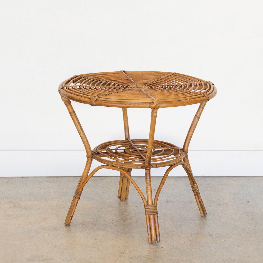 Great two-tier rattan side table from France, 1960's. Original rattan with circular rattan top and wrapped rattan detailing on legs. 