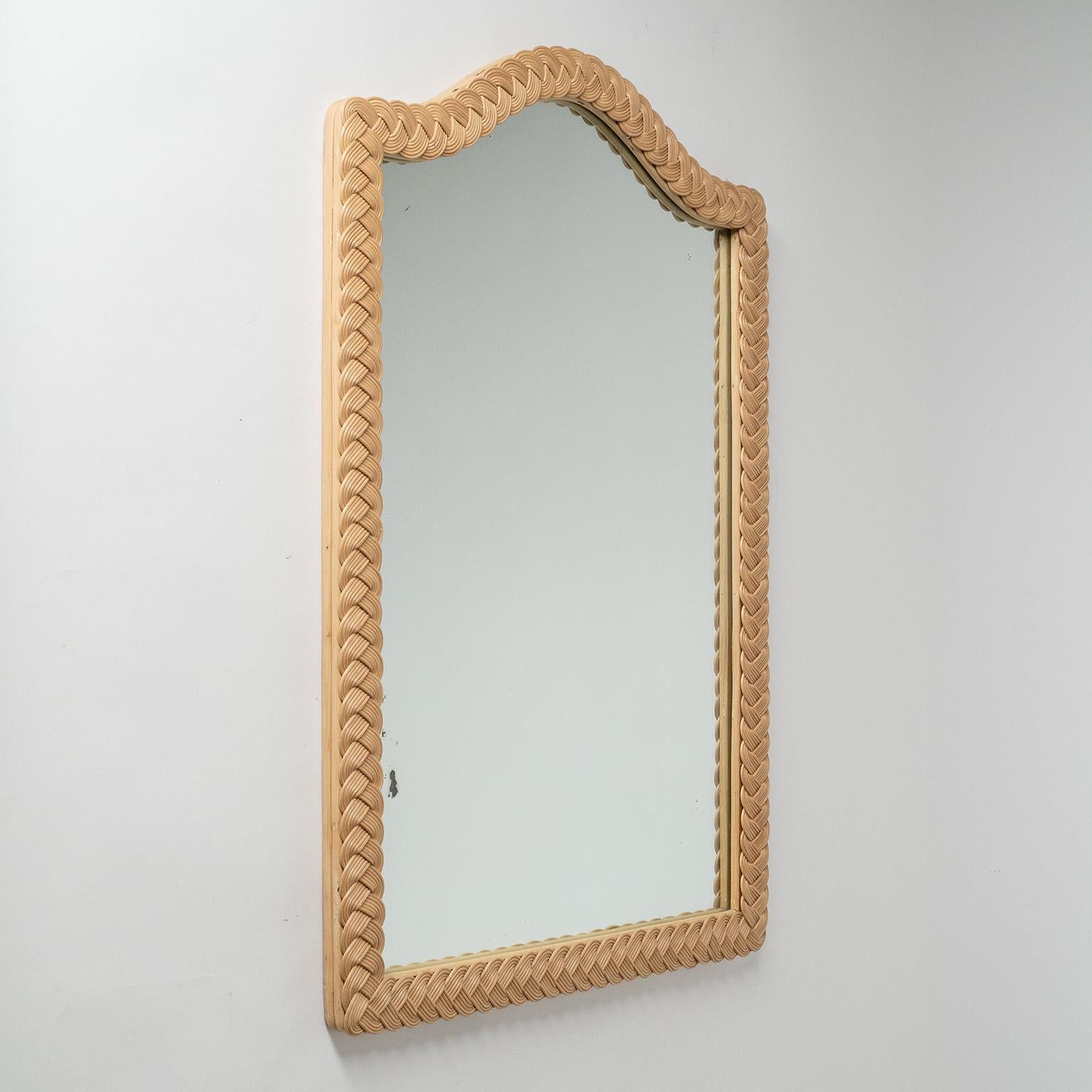 Rare French rattan mirror from the 1960-1970s. Unusual continuous braided rattan or wicker frame. Very good overall condition with some wear to the original mirror.