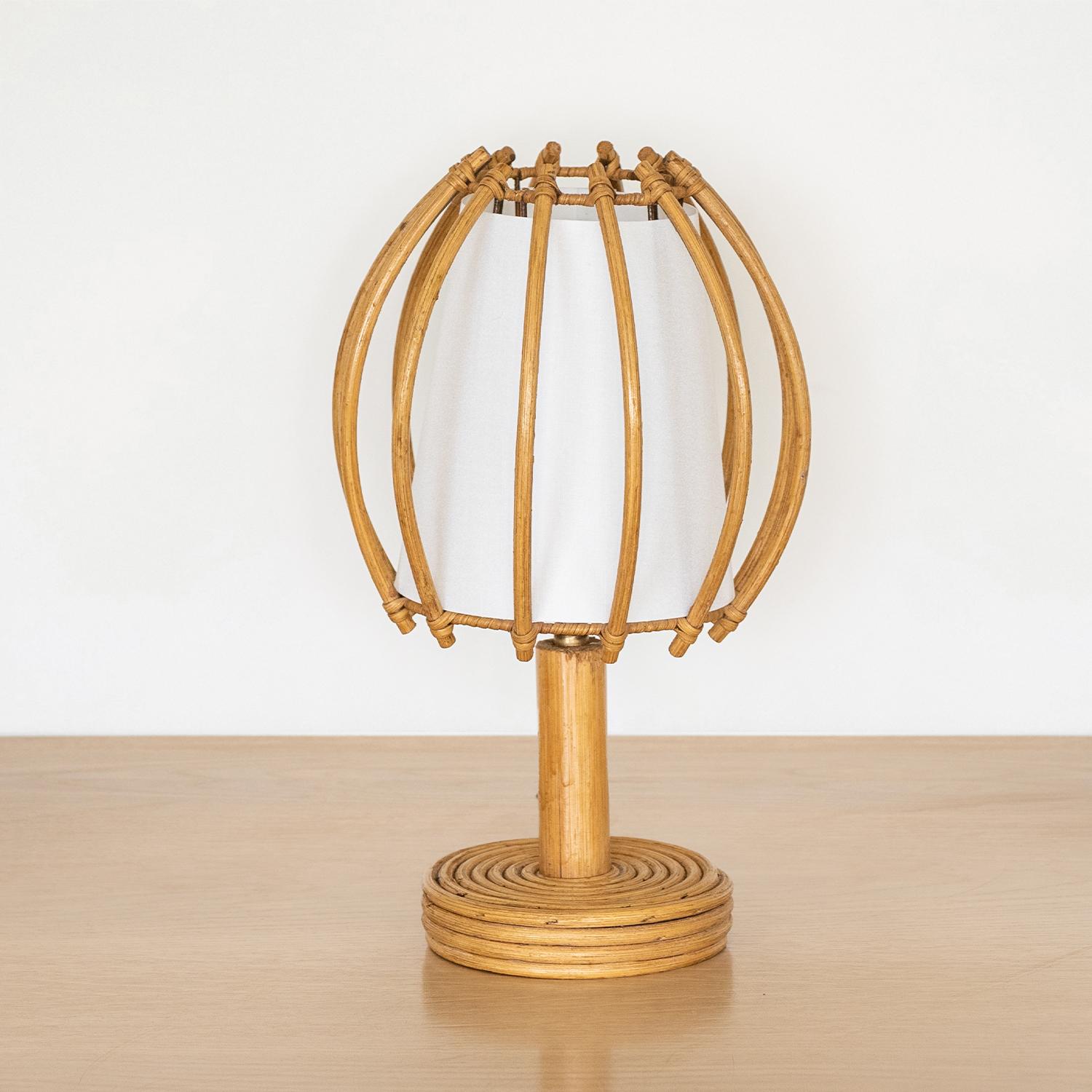 Great vintage rattan lamp from France, 1960s. Circular rattan base and stem with large rattan orb shade and new interior silk diffuser. Newly re-wired. Takes one E12 base bulb, 15 W or higher using LED.




