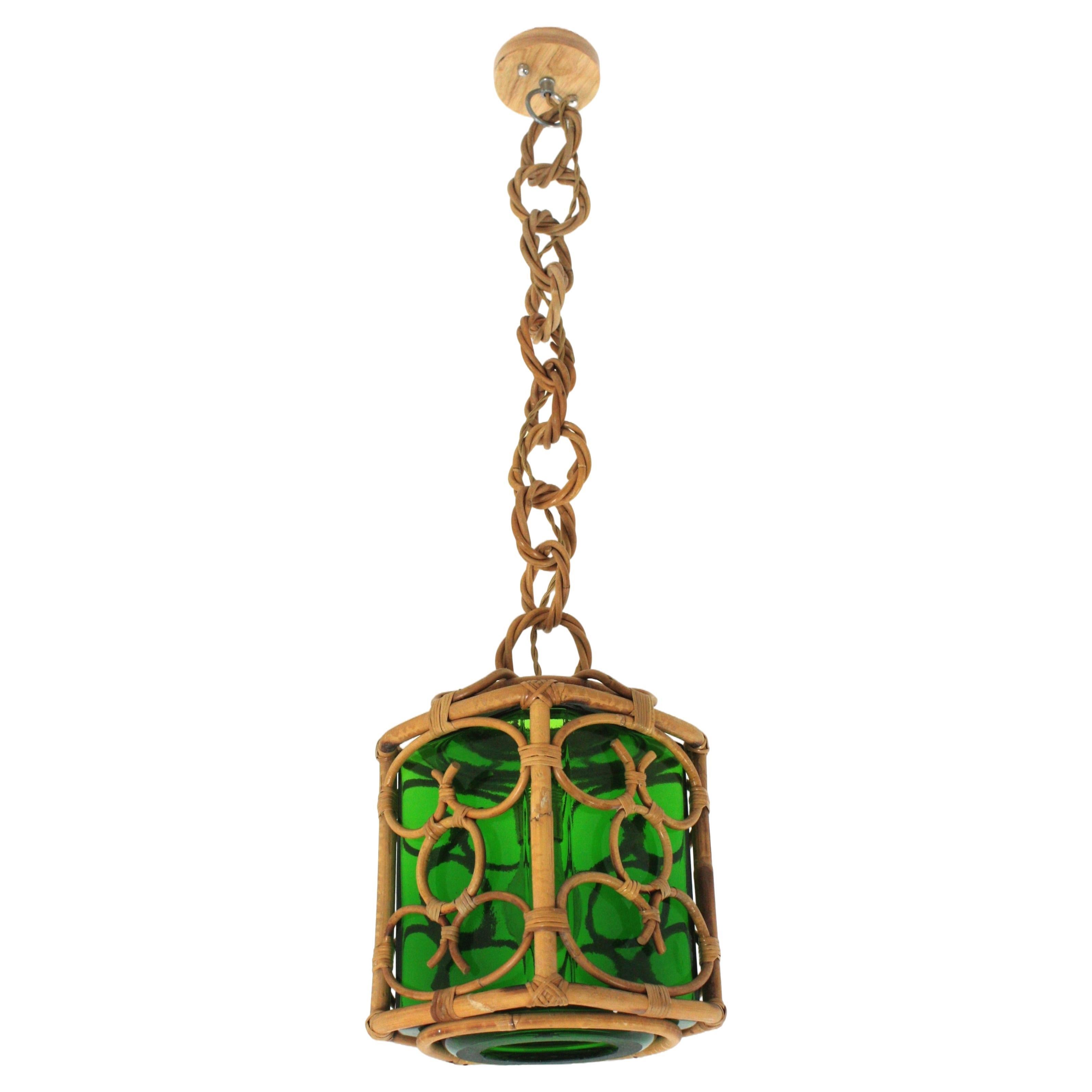 Square pendant light with glass lampshade, rattan, bamboo, France, 1960s.
Mid-Century Modern bamboo and rattan oriental inspired lantern with green blown glass lampshade.
This handcrafted ceiling lamp features a square shaped suspension with
