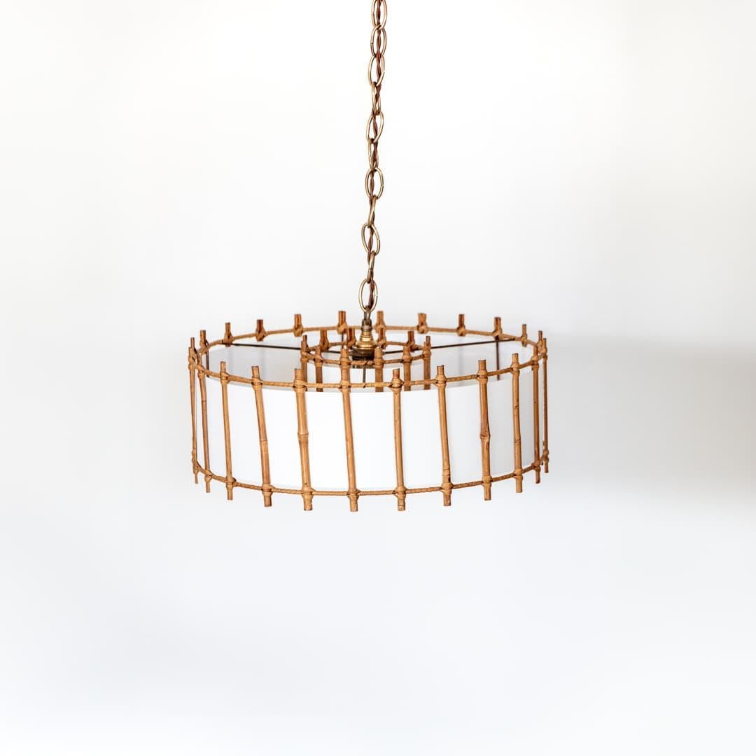 Circular rattan pendant light from France, 1960's. Original rattan frame with nice patina and age. Second smaller interior rattan shade with single bulb. Newly replaced silk interior lining and new brass canopy and chain. Takes one E12 base bulb, 25