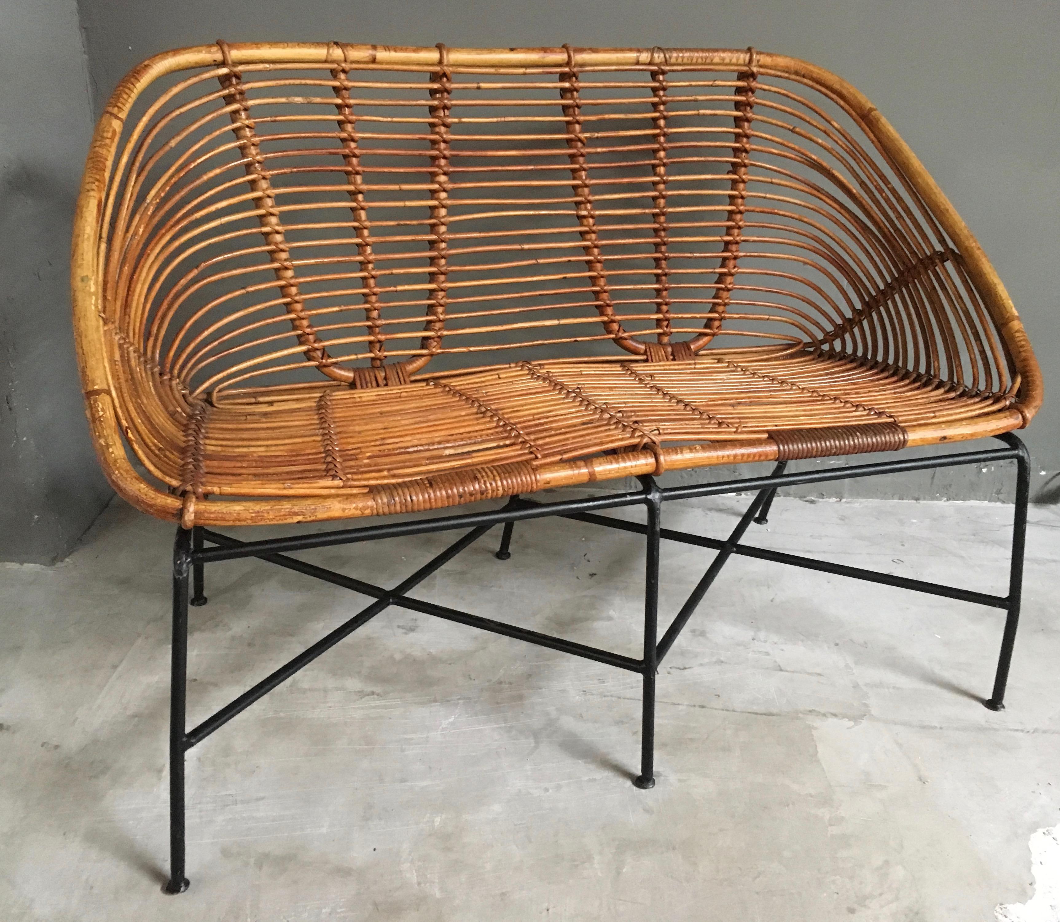 Elegant French rattan, wicker and iron settee. Rattan in excellent condition. Iron frame with criss-cross base. Excellent vintage condition. 

Matching chairs available in separate listing.
  
 