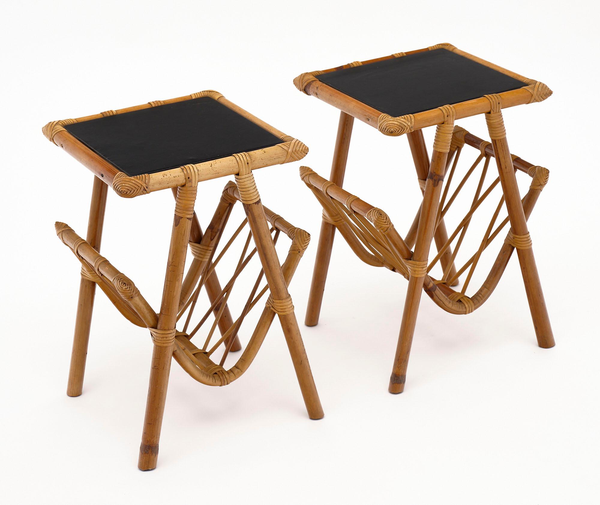 French Rattan side tables with black vinyl tops. The tables have magazine/book holders below.
