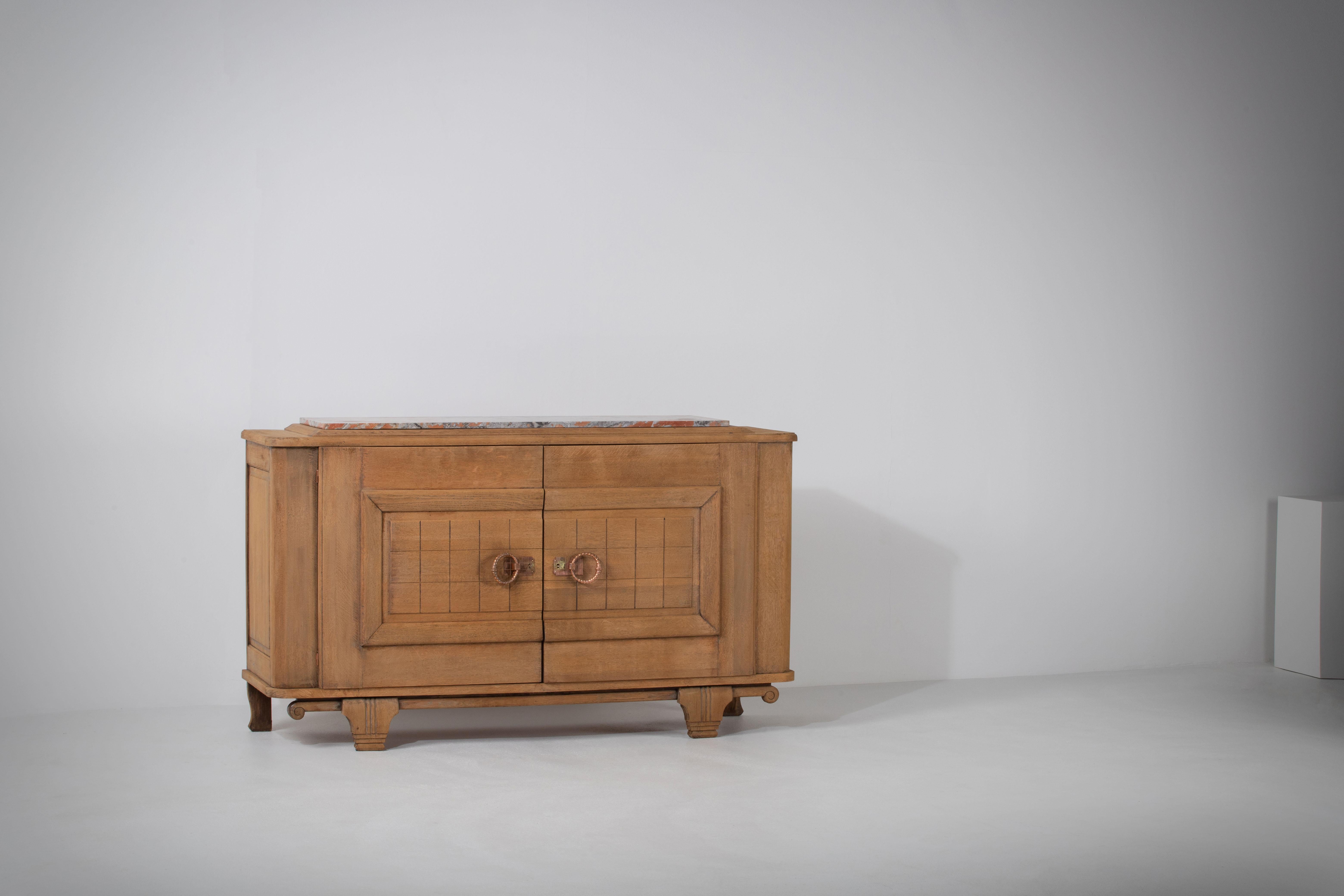 A large sideboard/credenza presumably by Charles Dudouyt. 
France, c1930s.
Consists of four doors providing shelves storage compartments and two central drawers. 
Brass detailing and graphic design doors make this piece really stand out.
The