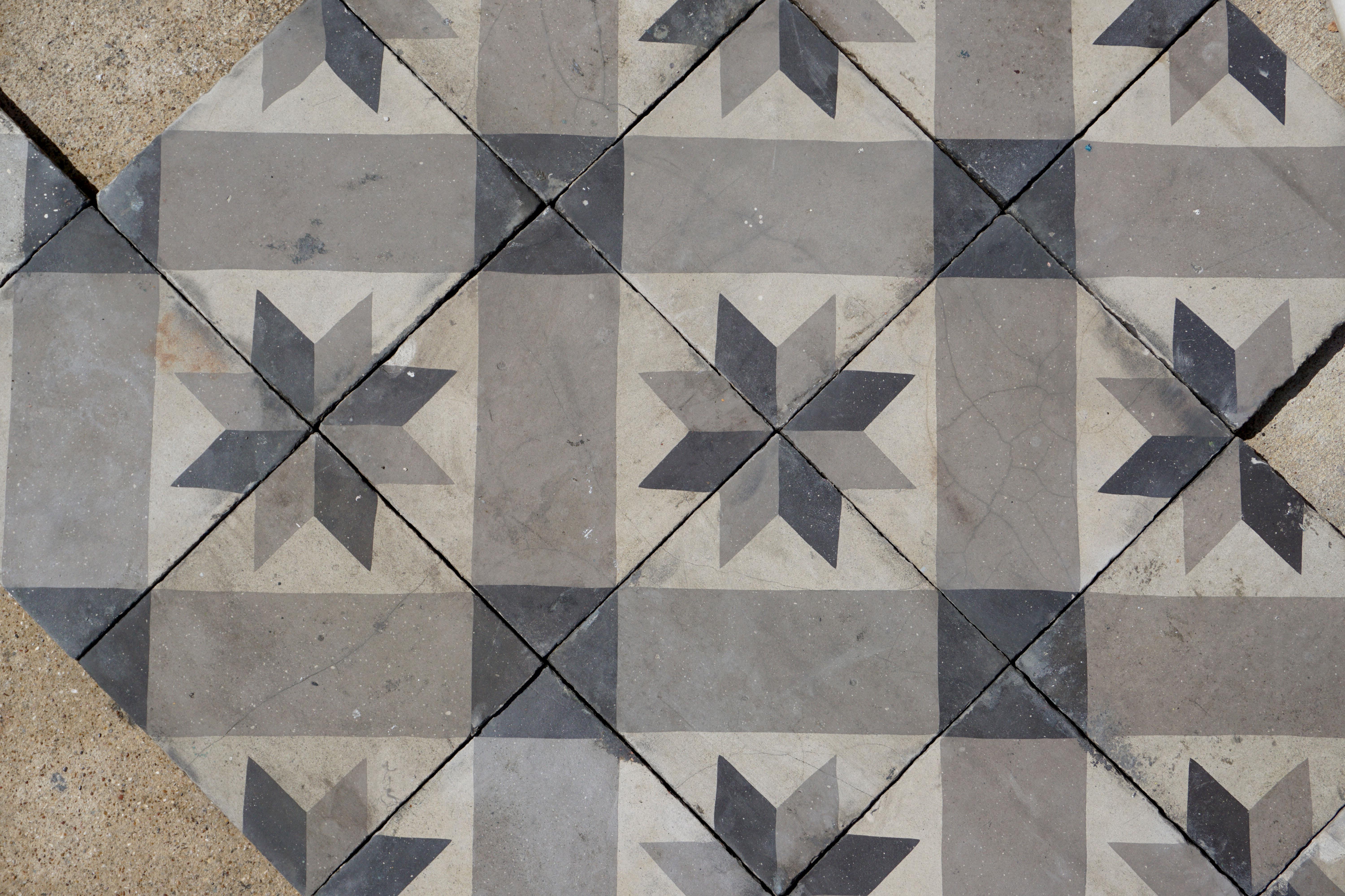 Stone tiles of black, grey, and white hues.

Measures: 296 pieces total, each piece 8'' x 8''. 62 border, 234 field. 

Total lot is 127 square feet. 27 square feet border tile, 100 square feet field.