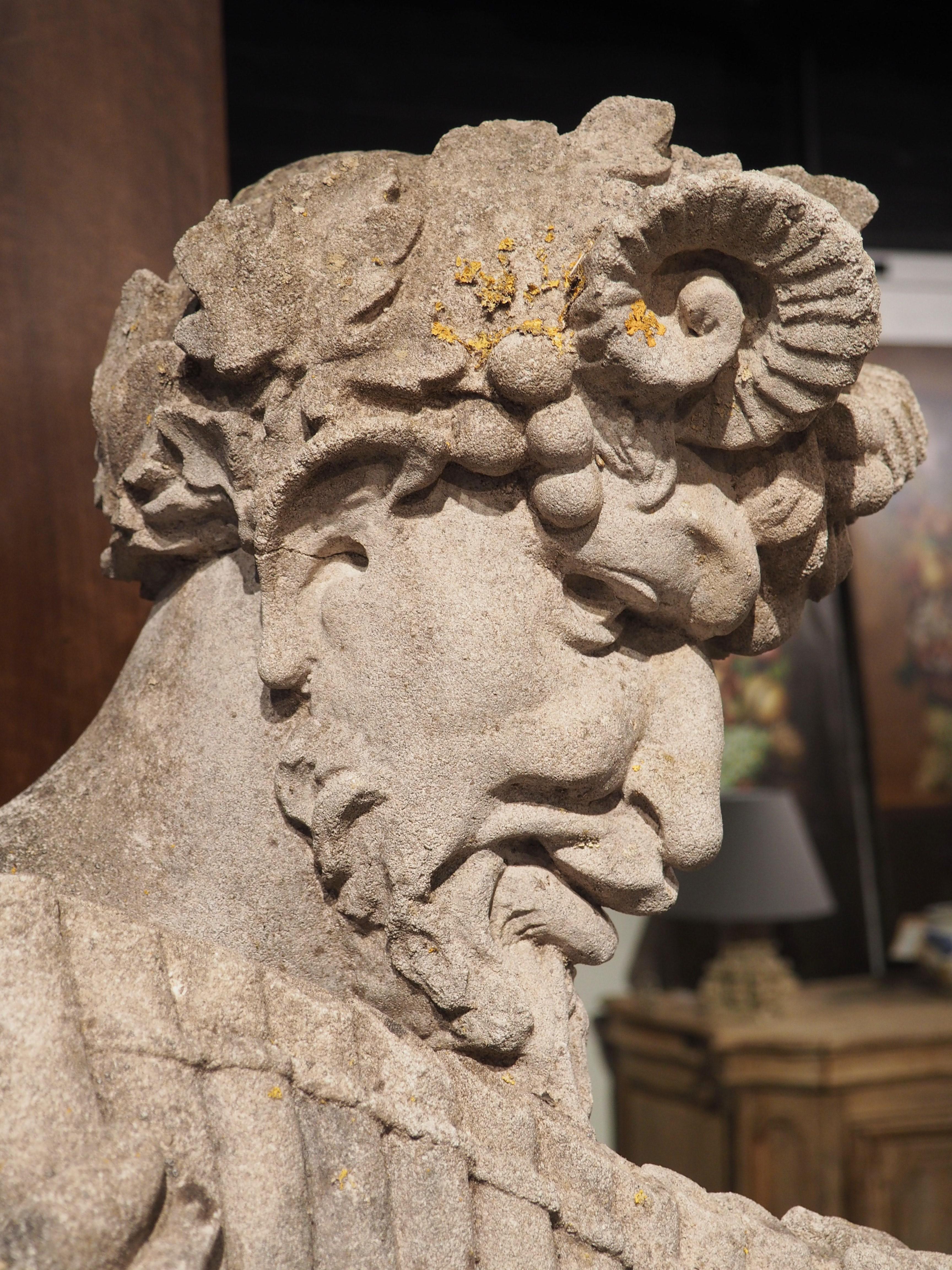 Cast in reconstituted stone, circa the 1950s, this statue of the Greek god, Pan, rests on top of an Ionic order capital, standing over six feet tall. Discovered at a chateau in Vicennes, France, less than five miles east of Paris, the statue was