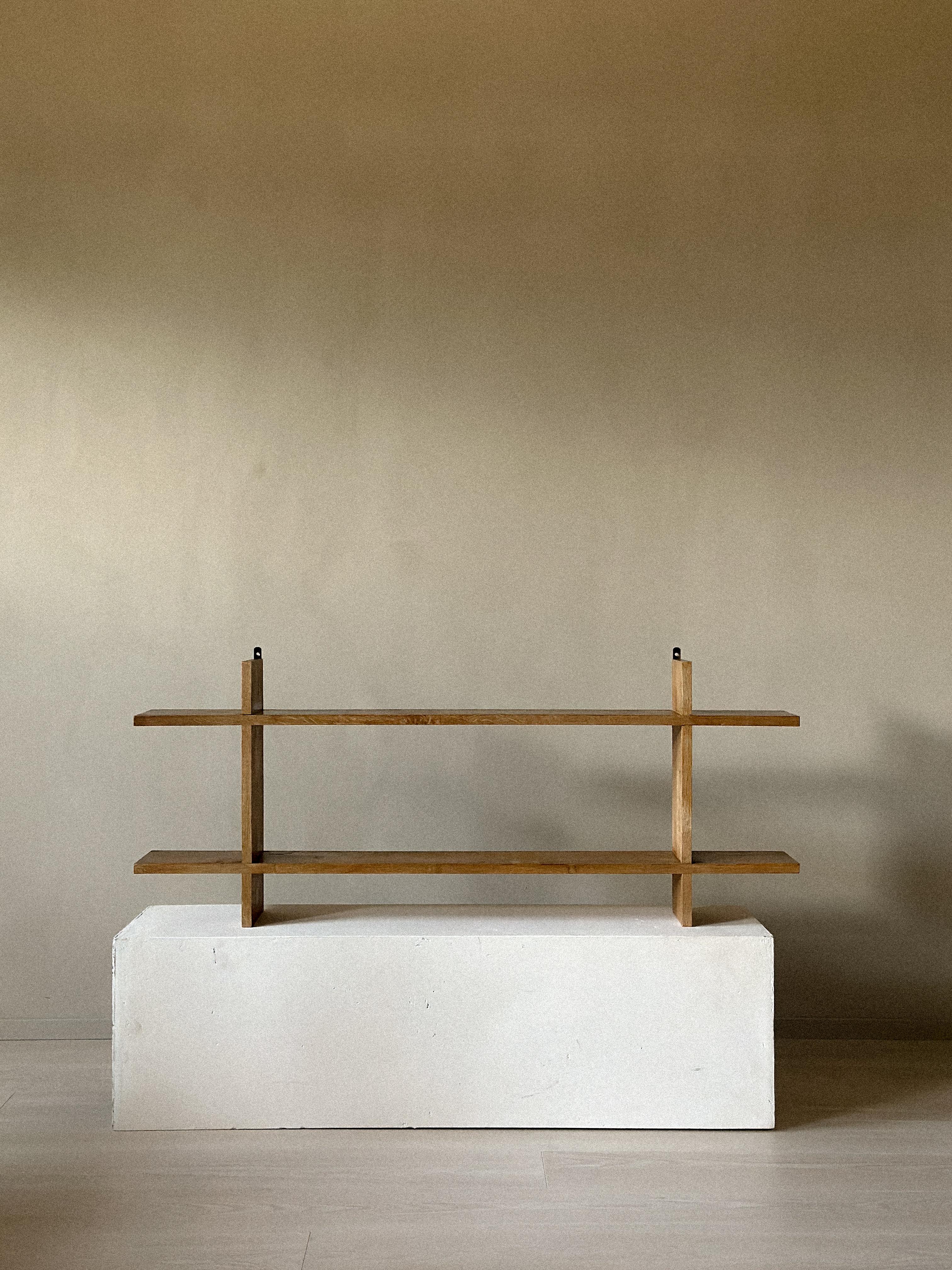 Oak wall shelf from France, c. 1950s. A piece from the French Reconstruction era, with clean lines and a warm, natural patina. Simple, functional design that reflects the understated character of the period. Wear consistent with age and use. Marks,
