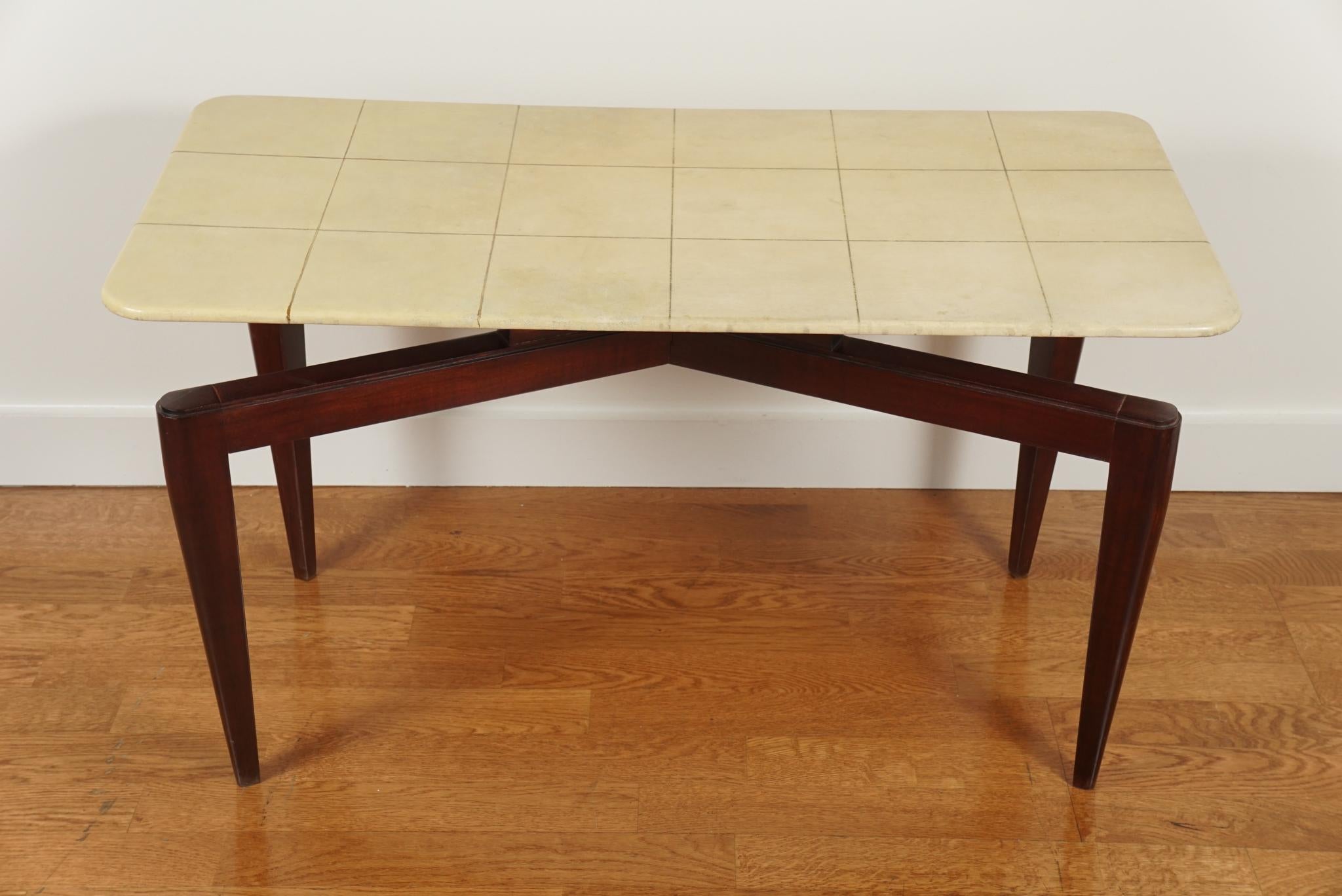 A parchment wrapped cocktail table, resting on unusual mahogany legs.
Signed: Fabrique De Meubles
Henri Bonjour & Co. Lyon, France.