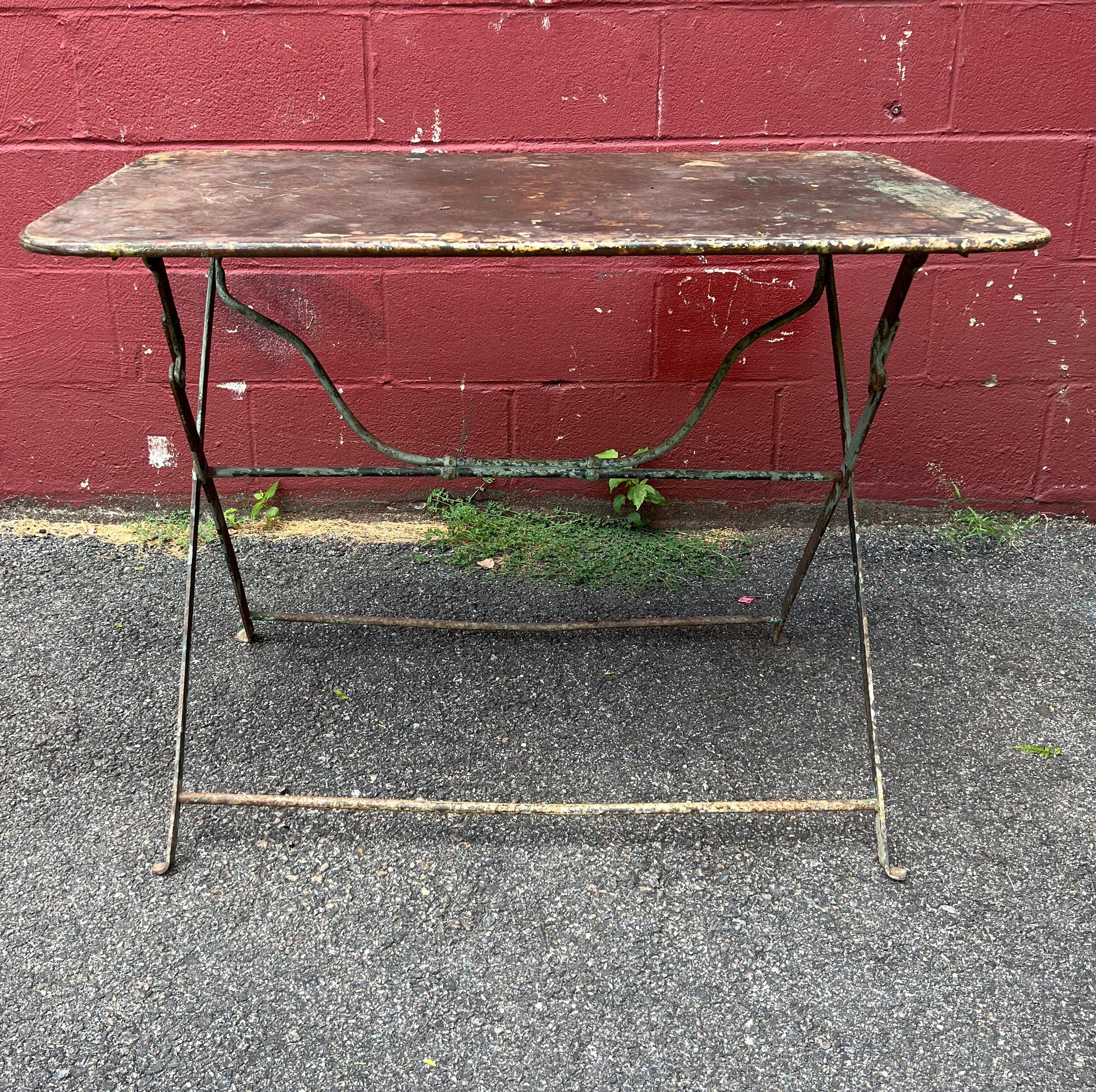 This charming French bistro or garden table is a perfect addition to any outdoor space, evoking memories of the picturesque South of France and Provence. Its original distressed green paint gives it a rustic and vintage feel, adding character and