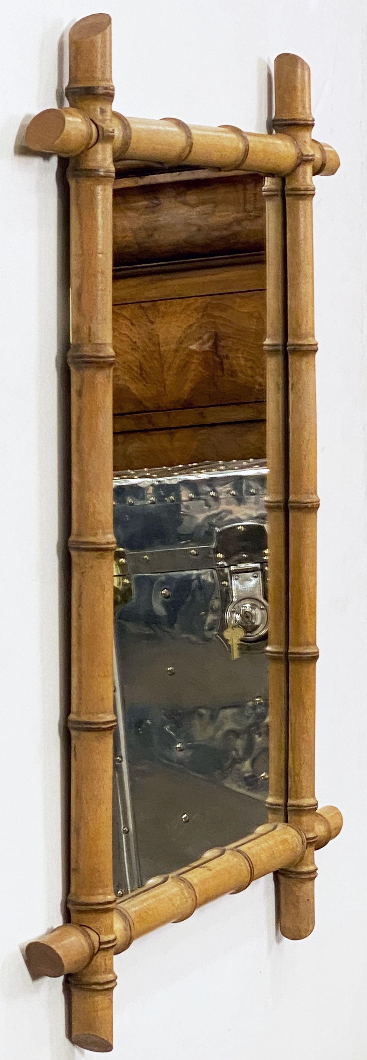 A large French rectangular faux-bamboo mirror from the early 20th century, featuring a turned faux bamboo rectangular frame with intersecting corners surrounding a central mirror plate. Can be displayed vertically (portrait) or horizontally