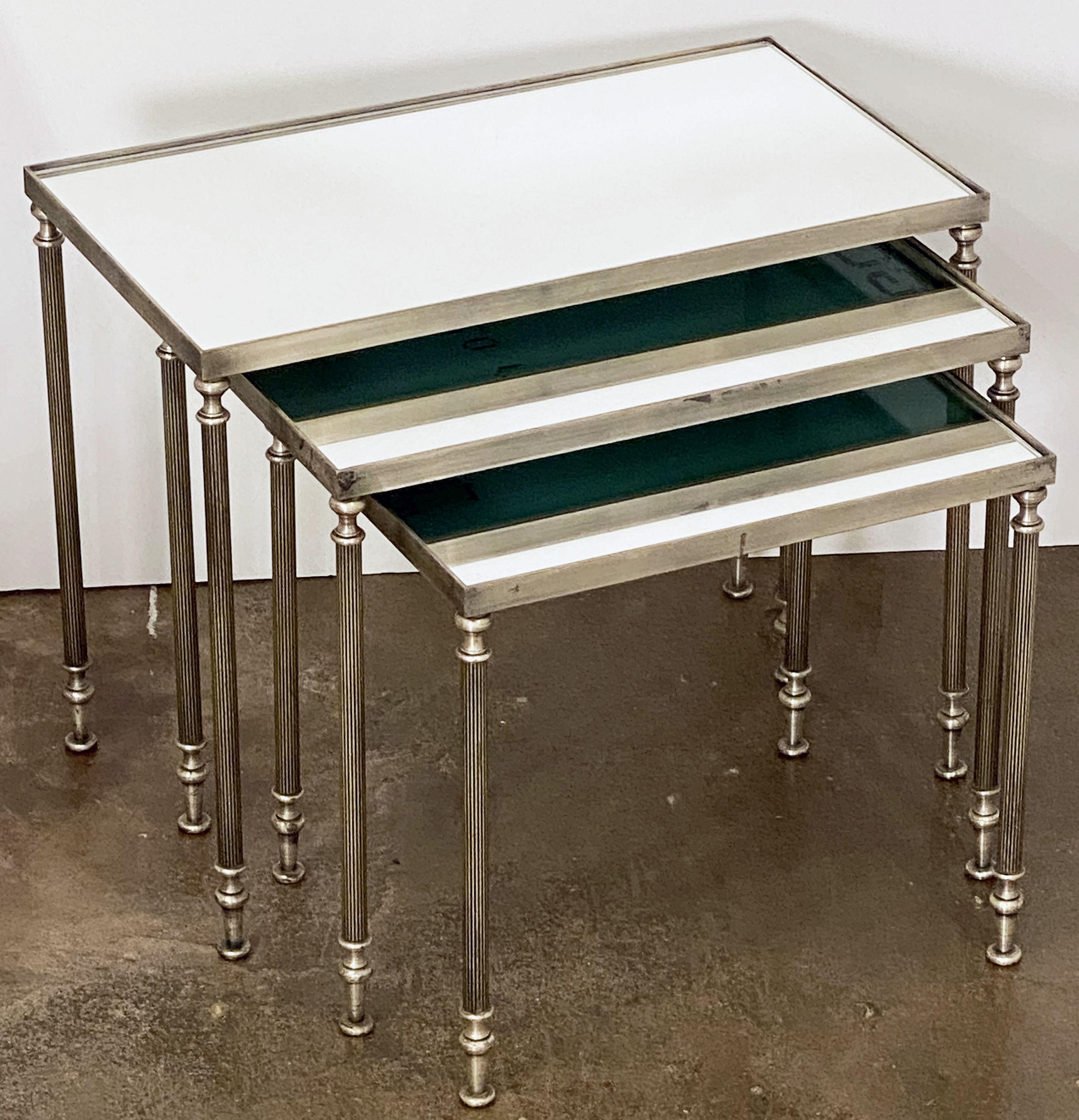 A fine set of French stacking or nesting low tables with a stylish Mid-Century Modern design. 
The set featuring three fitted tables - each with a rectangular frame inset with a mirrored glass top.

Great for use as cocktail or coffee tables as