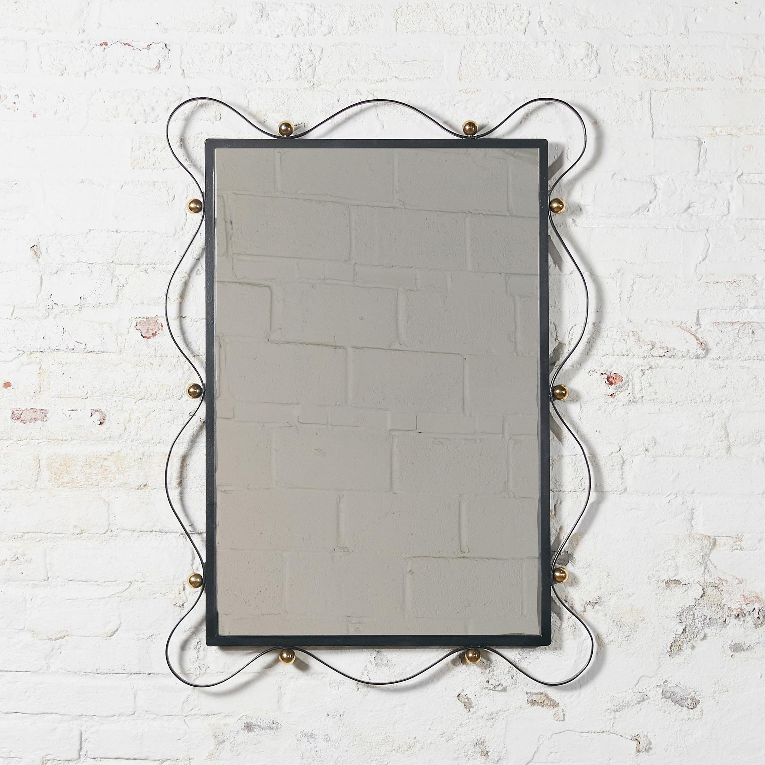 French rectangular wall mirror. Frame made in black metal, embellished with curved metal ribbon attached by bronze bolts.
 