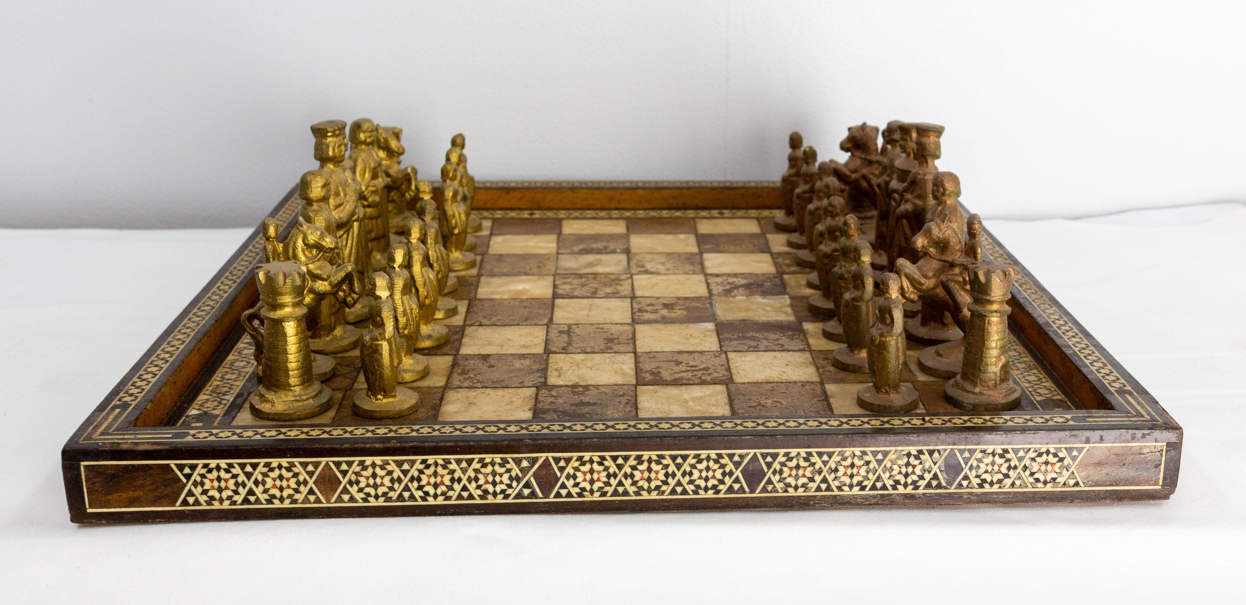Chess in red and black marble. The pieces are in pink marble with with some yellow veins.
The board is made with a marble in which we see fossilized plants.
Made circa 1980, each piece is handmade.

Height of the pieces:
from 1.57 to 9.95 in.