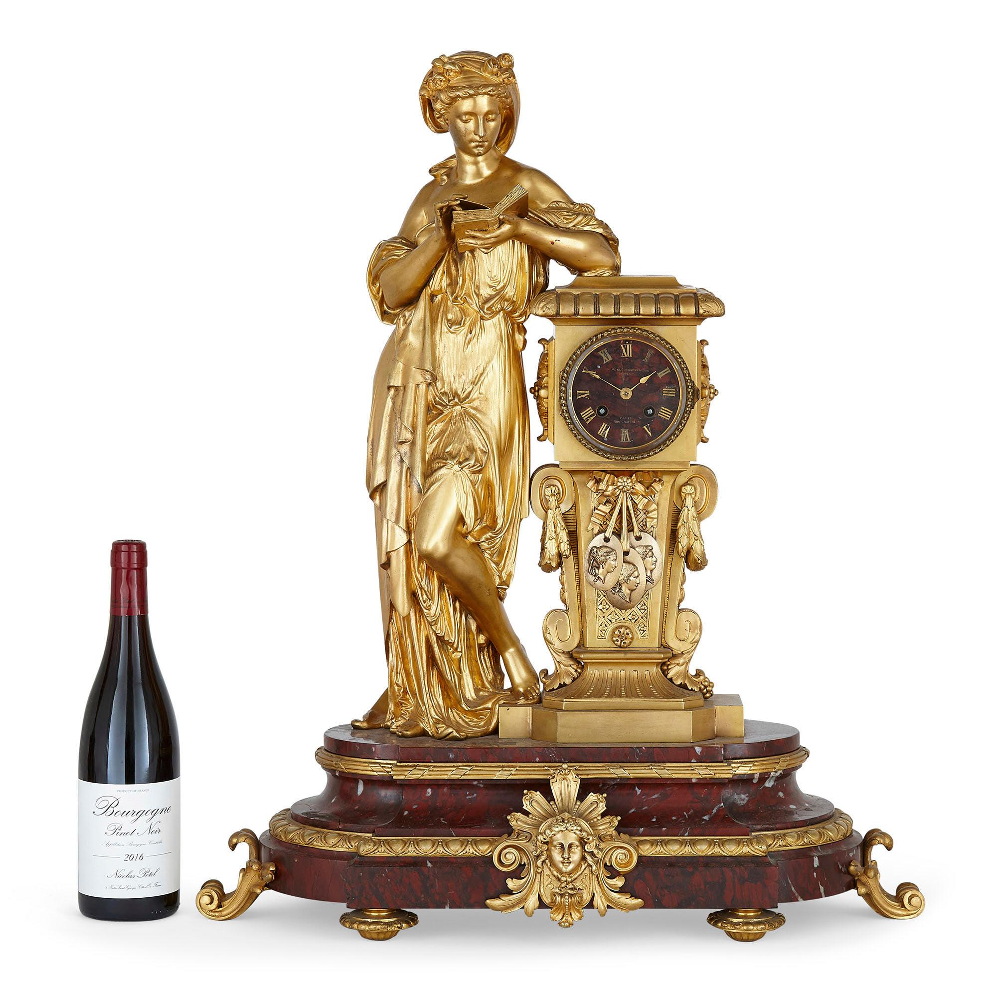 French red marble and gilt bronze Neoclassical style matched clock set
French, late 19th Century
Clock: Height 70cm, width 57cm, depth 23cm
Candelabra: Height 70cm, width 31cm, depth 24cm

This elegant three-piece matched clock set features a