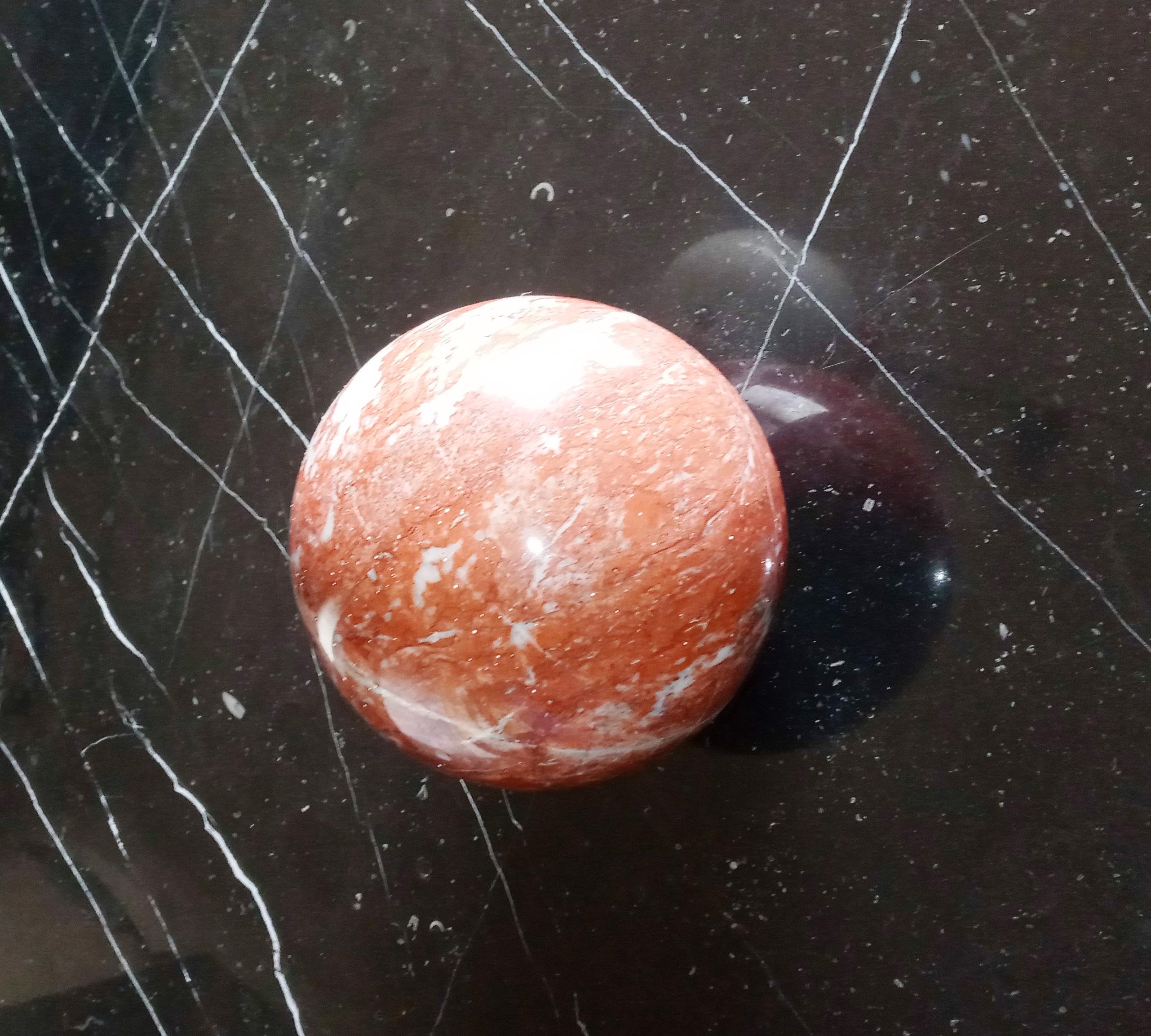 French red marble sphere, 1980s. Equipped with a small flat base to facilitate support.