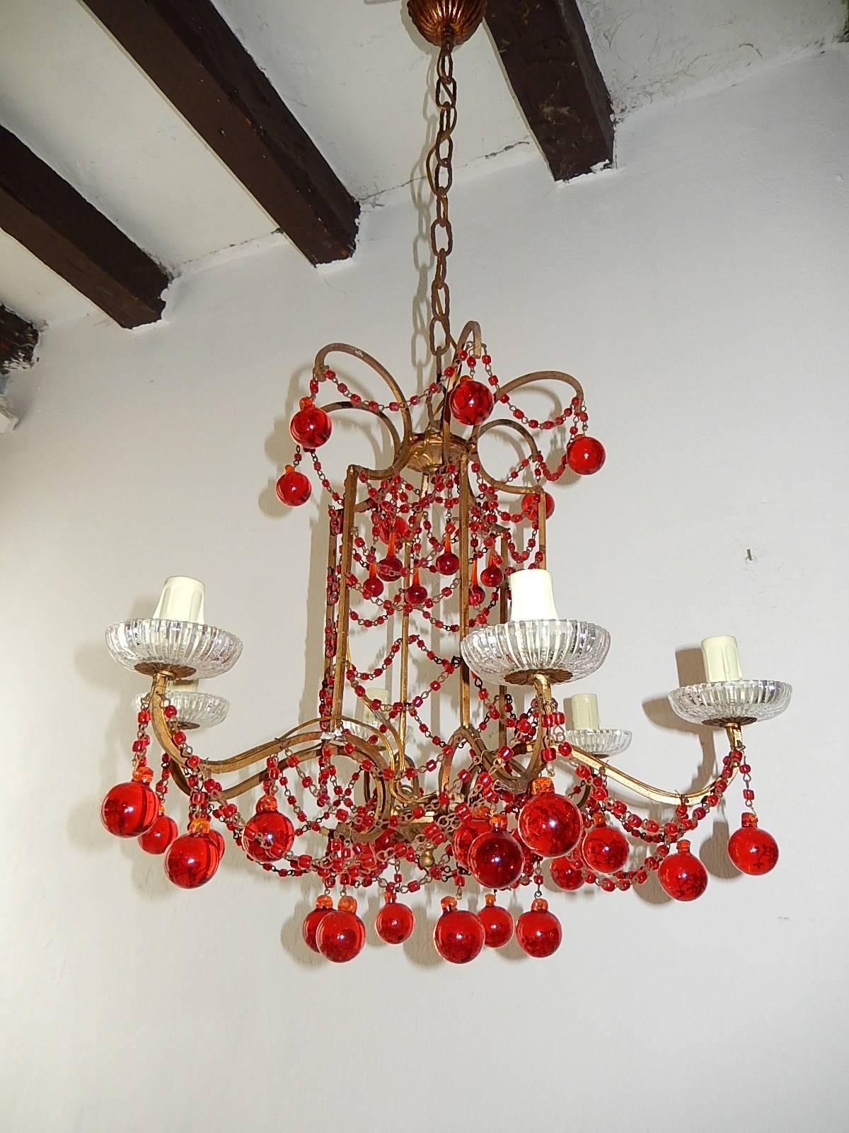 Housing six lights, rewired and ready to hang. Crystal bobeches. Swags of macaroni beads in red with matching red Murano balls. Adding 18 inches of original chain and canopy still intact. Free priority shipping from Italy.