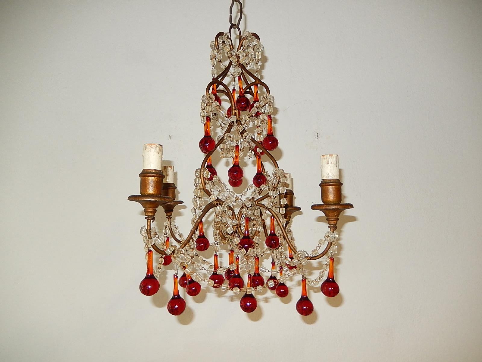 Housing 4-light, will be rewired with certified US UL sockets for the USA and appropriate sockets for all other countries, ready to hang. Wood bulb posts. Swags of macaroni beads and rare red Murano drops. Adding 12 inches of original chain still