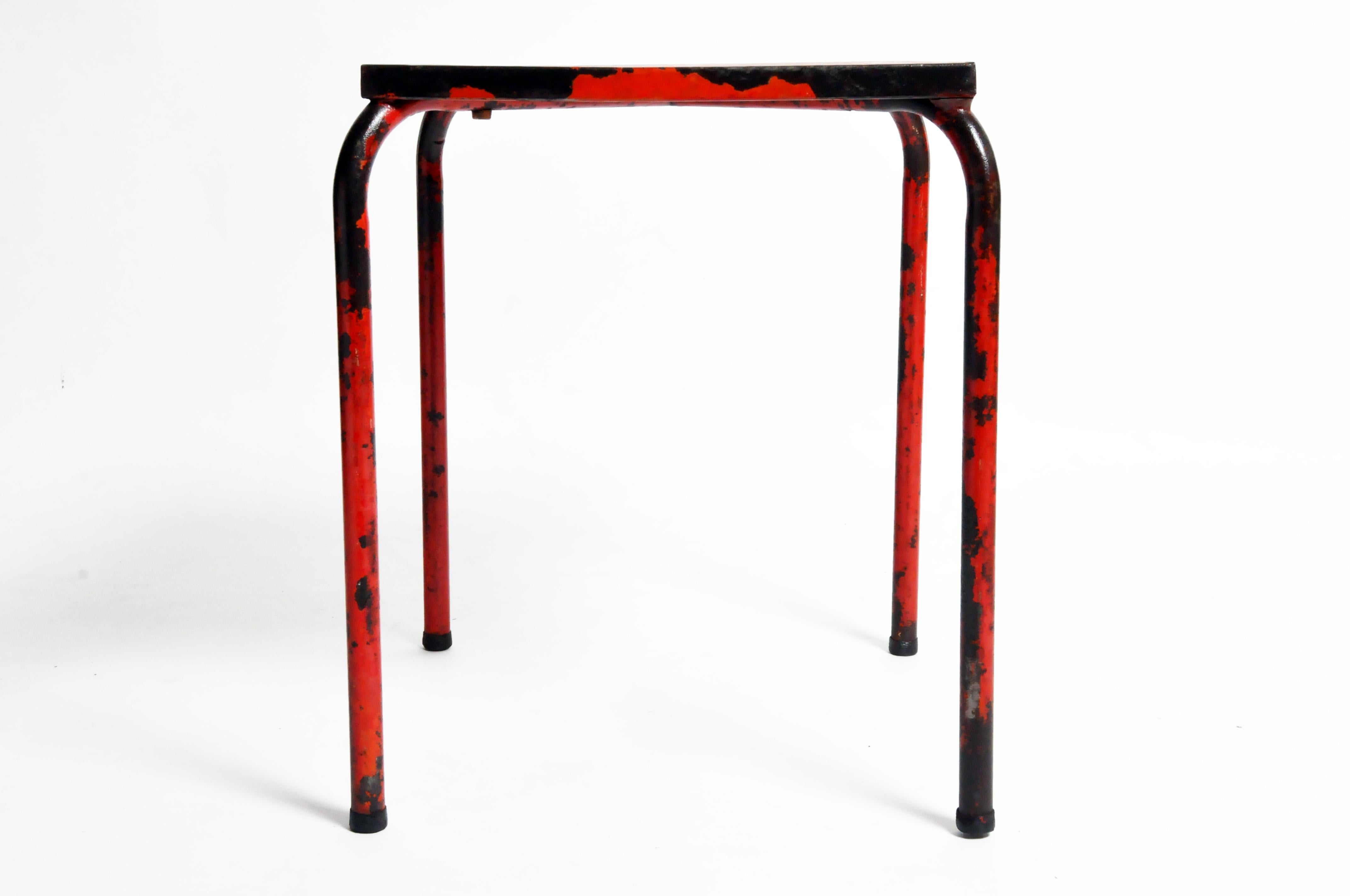 This rustic red metal table is from France and was made, circa 1960.
This brightly painted cafe table has an artistically aged surface due to usage.