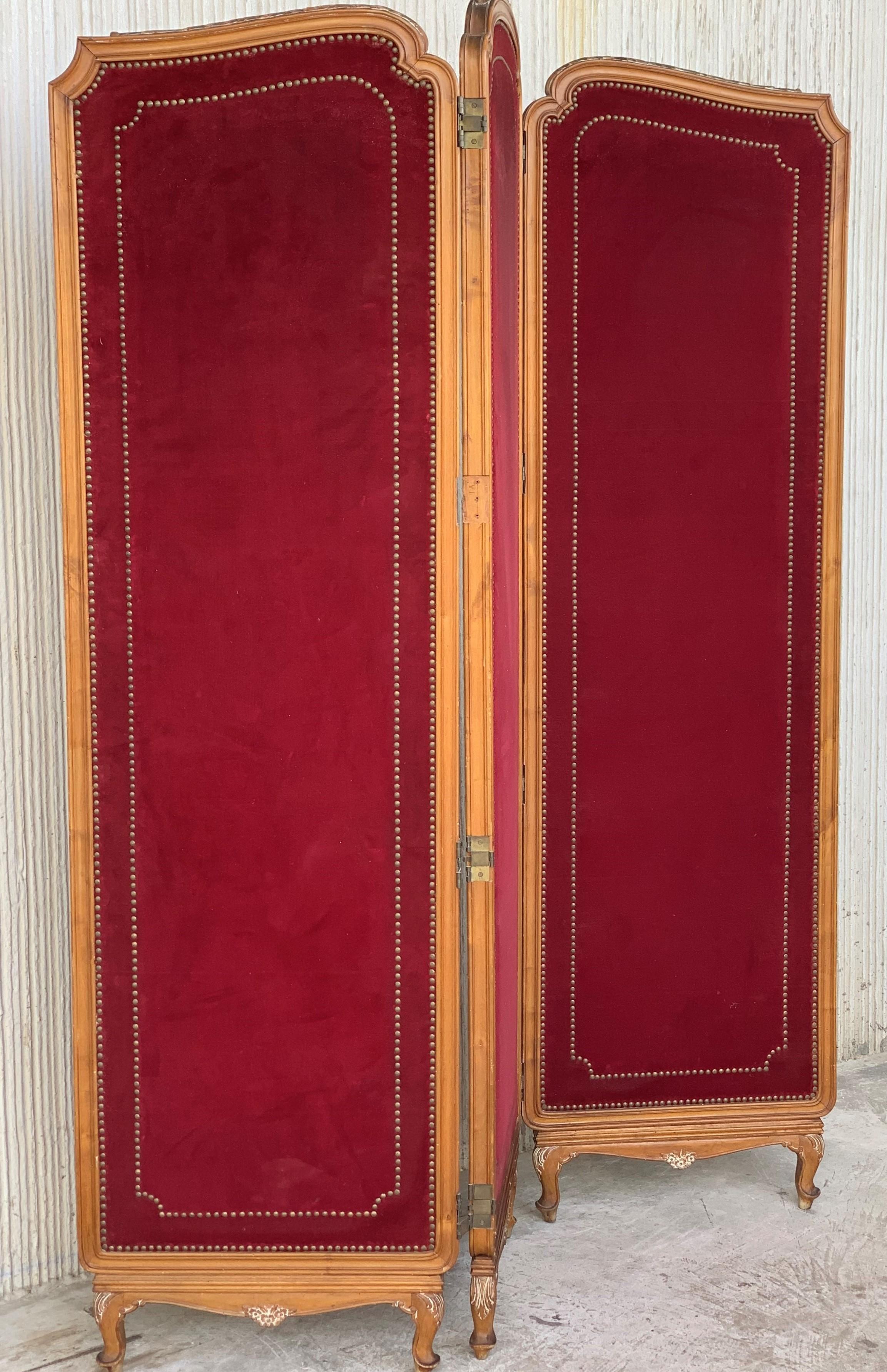French red velvet three-panel screen adorned with antique brass tacks.
Beautiful carved legs and tops.