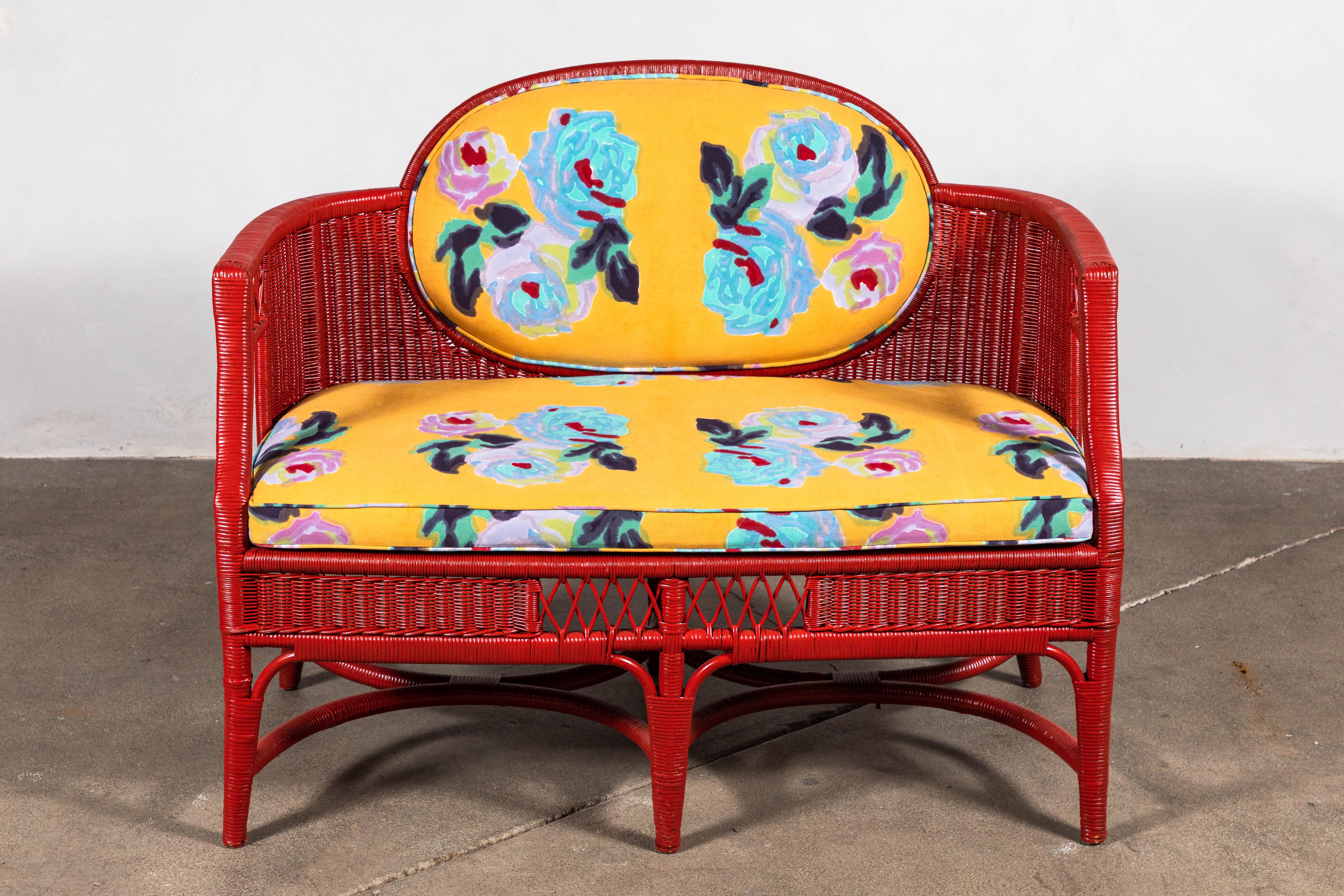Newly painted red French wicker settee newly upholstered in a fun floral print by Italian Textile Designer, Lisa Corti.