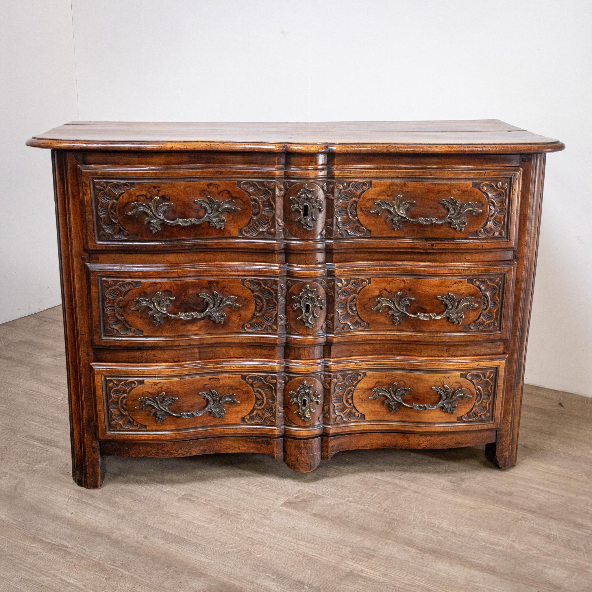 A wonderful piece of furniture, this fine 18th century French Régence commode or chest of drawers has a feel of the massive about it. With the beautiful patina and deep colour expected for a piece of walnut of this age, it has lovely large