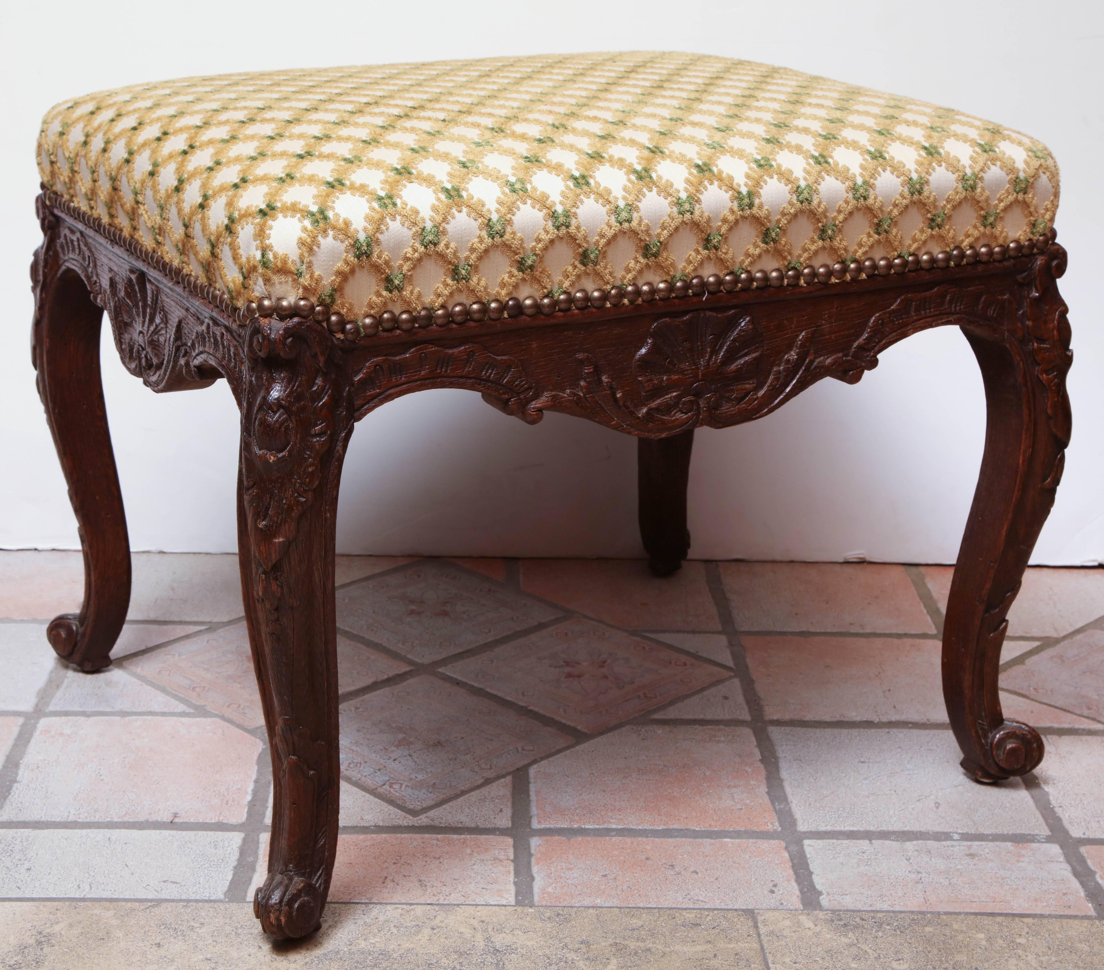 French Regence carved walnut stool with carved shell, cabriole legs and scroll feet.