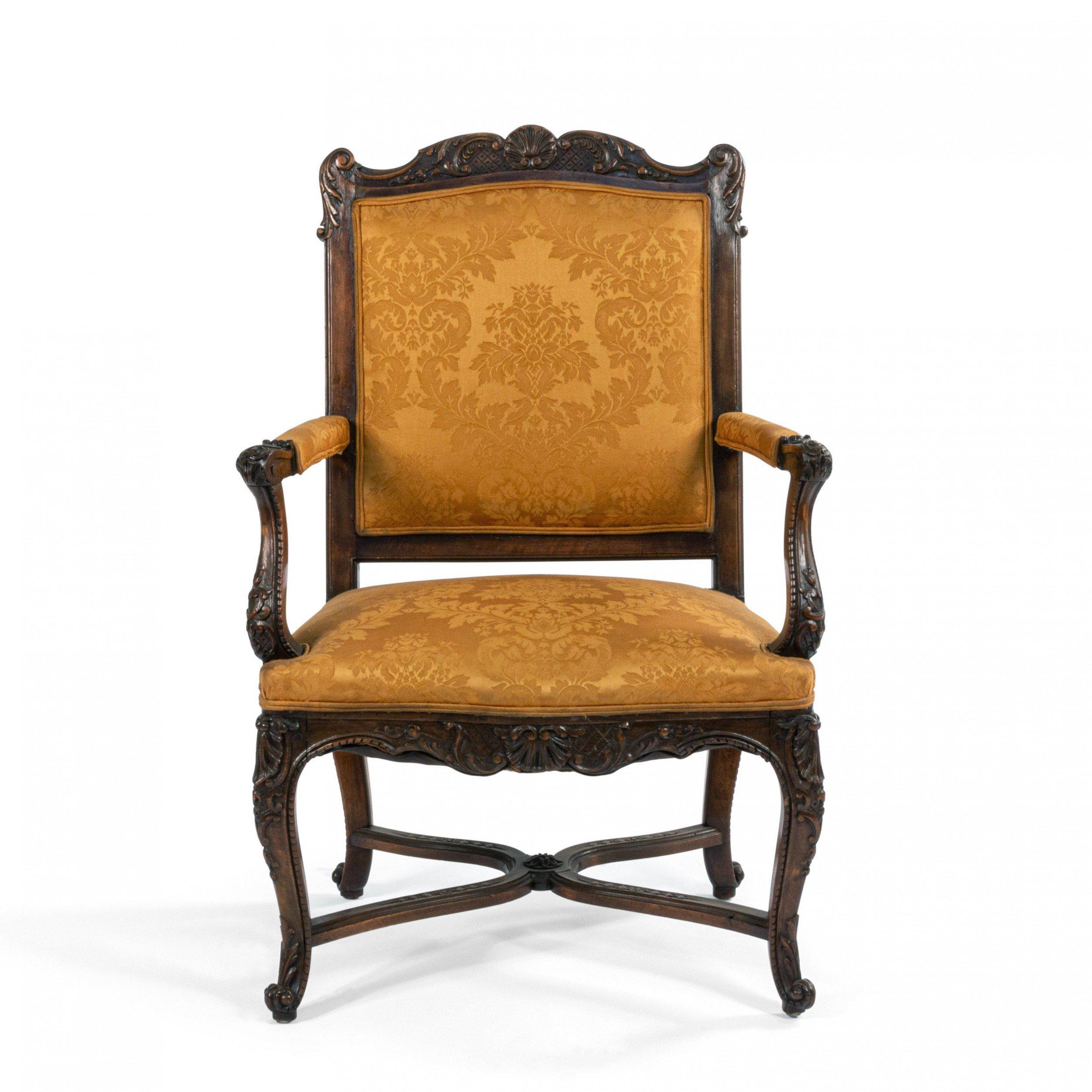 Pair of French Regence style (19th century) walnut armchairs with gold upholstery.