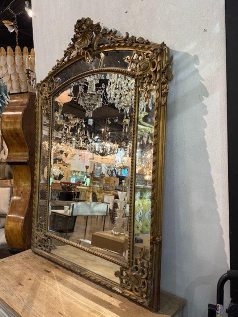 19th century French Regence carved and gilt-wood mirror. A French Régence carved and giltwood mirror is a showstopper—ornate, symmetrical, and dripping with gilded detail. Circa 1870. 42w x 58h