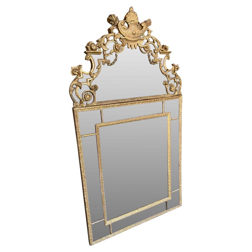 A very beautiful Regence period - early 18th century Mirror. Beautifully crafted in giltwood with its original mercury glass mirror. A stunning accent piece.
