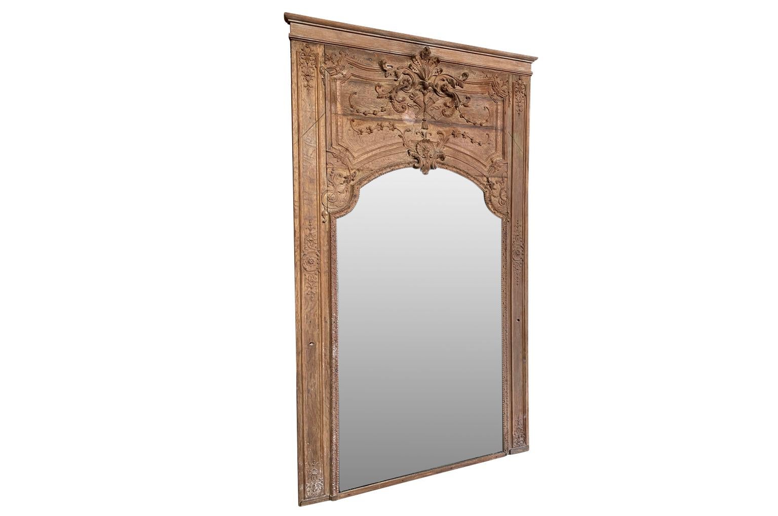 A very beautiful and grand scale French Regence period Trumeau in washed oak. Lovely carving detail in bas and haut relief. A stunning statement piece. Please note the small holes - one on each side of the trumeau. Originally, a pair of appliques or