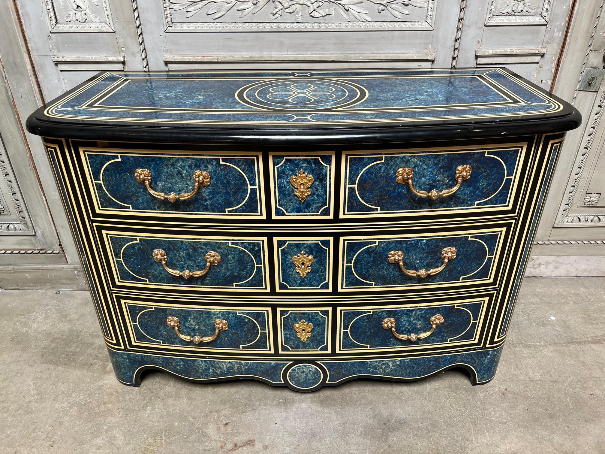 A French Regence style Commode with a black blue and white lacquered finish with a parquetry design. This fabulous commode - chest of drawers is highly decorative and belonged to the well known Parisian entertainer, Michou.