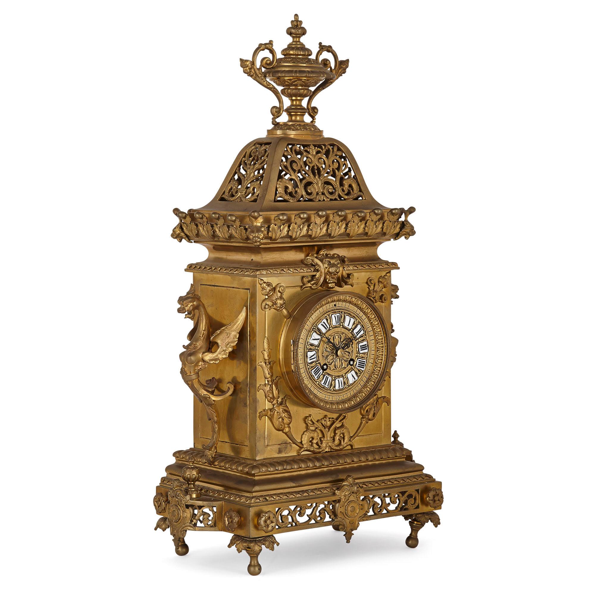 French Régence style gilt bronze clock garniture
French, late 19th century
Clock: Height 60cm, width 36cm, depth 20cm
Candelabra: Height 67cm, width 25cm, depth 25cm

This wonderfully ornate three-piece clock set is crafted from gilt bronze in