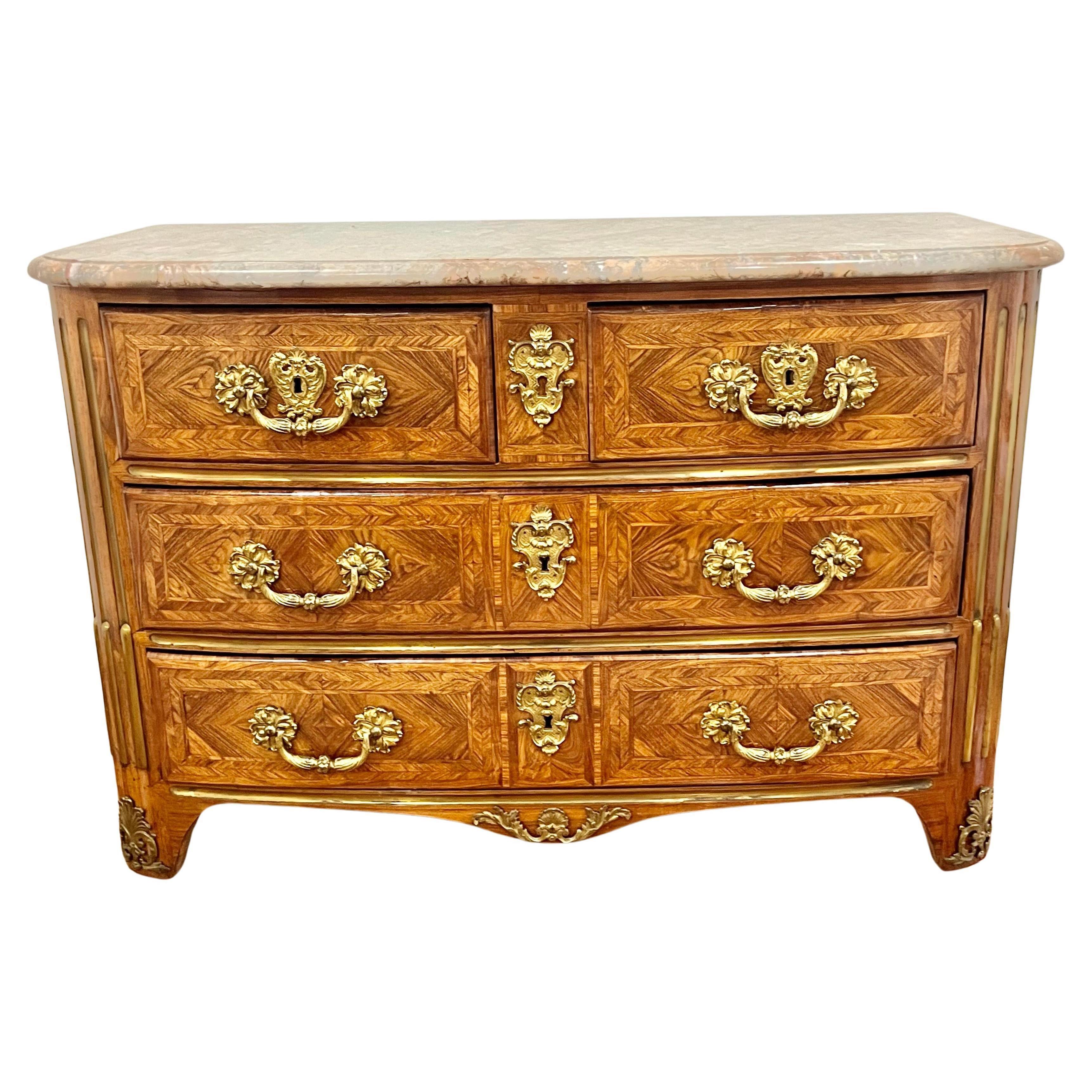 Primarily of tulipwood and kingwood with heavy gilded drawer mounts  . Sturdy . Presents very well . The drawers reflecting the fabled tulip by the gilt rosettes. The veneers laid in flattering patterns crossbanded and with tulips.  The sides with
