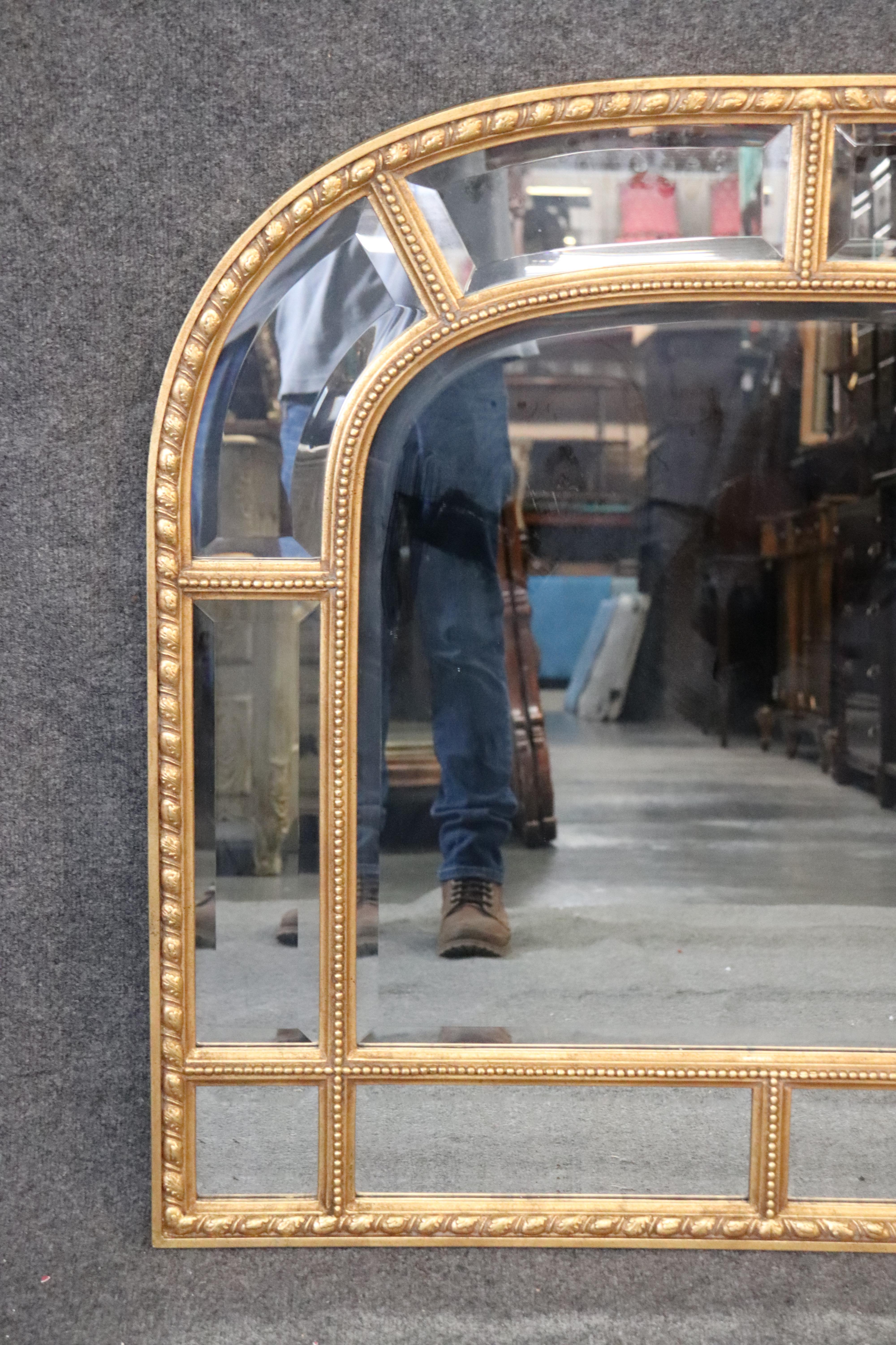 This is a beautiful gilded wood and gesso carved Decorative Arts mirror made in Italy for the famous New York firm. The mirror is perfect for a mantle or over a buffet. Measures: 39 tall x 41 wide x 1 deep.