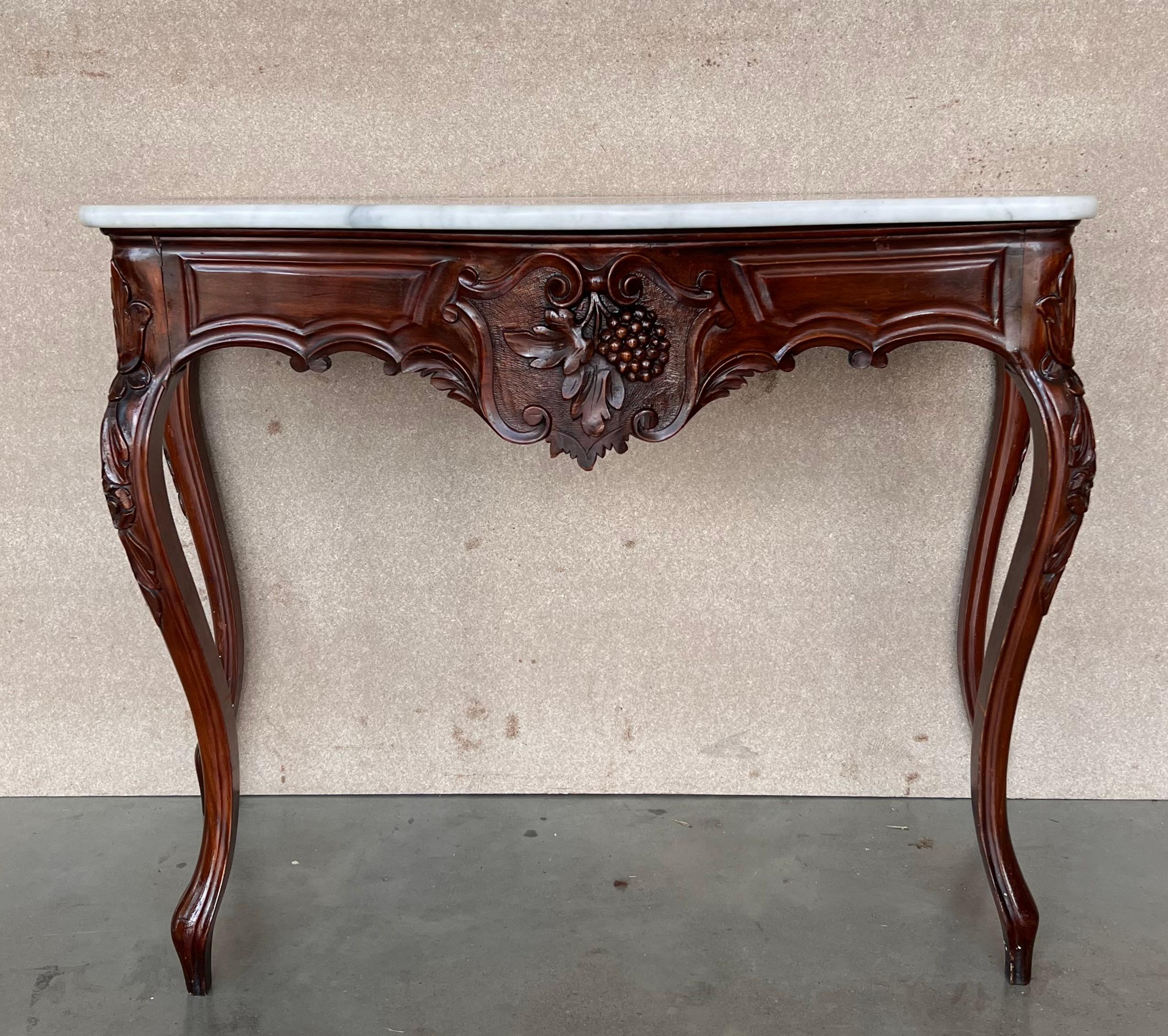 20th French Regency carved walnut console table with marble top

20th century French Regence style beautifully carved with leaves walnut console. White marble top with carved front, over hand-carved frieze supported by four cabriole legs. Very