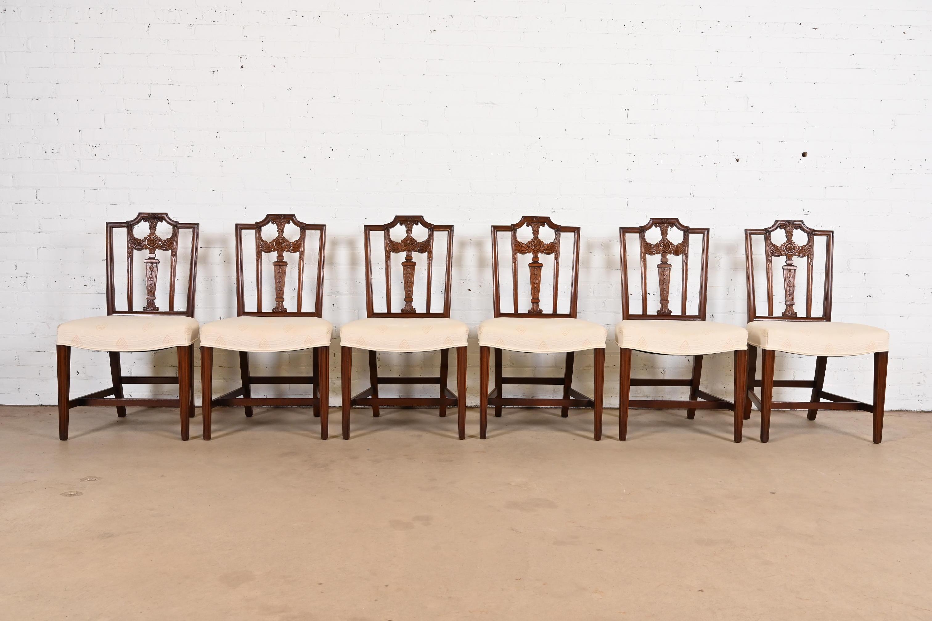 A gorgeous set of six French Regency Louis XVI style dining chairs

In the manner of Henredon

USA, Circa 1980s

Sculpted solid mahogany frames, with upholstered seats.

Measures: 20