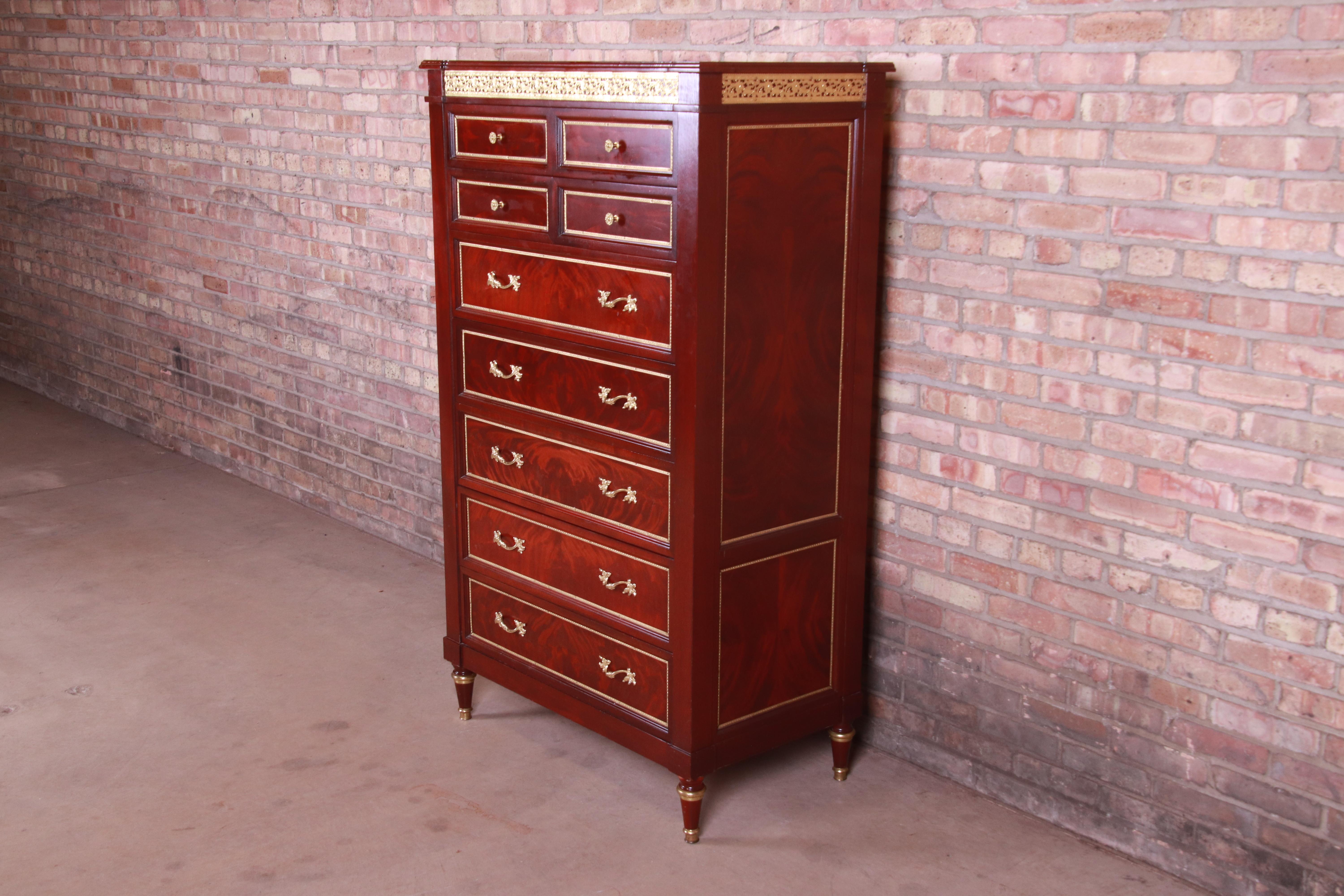 A beautiful French Regency Louis XVI style seven-drawer highboy dresser,

late 20th century

Flame mahogany, with mounted brass ormolu and original brass hardware and trim.

Measures: 36