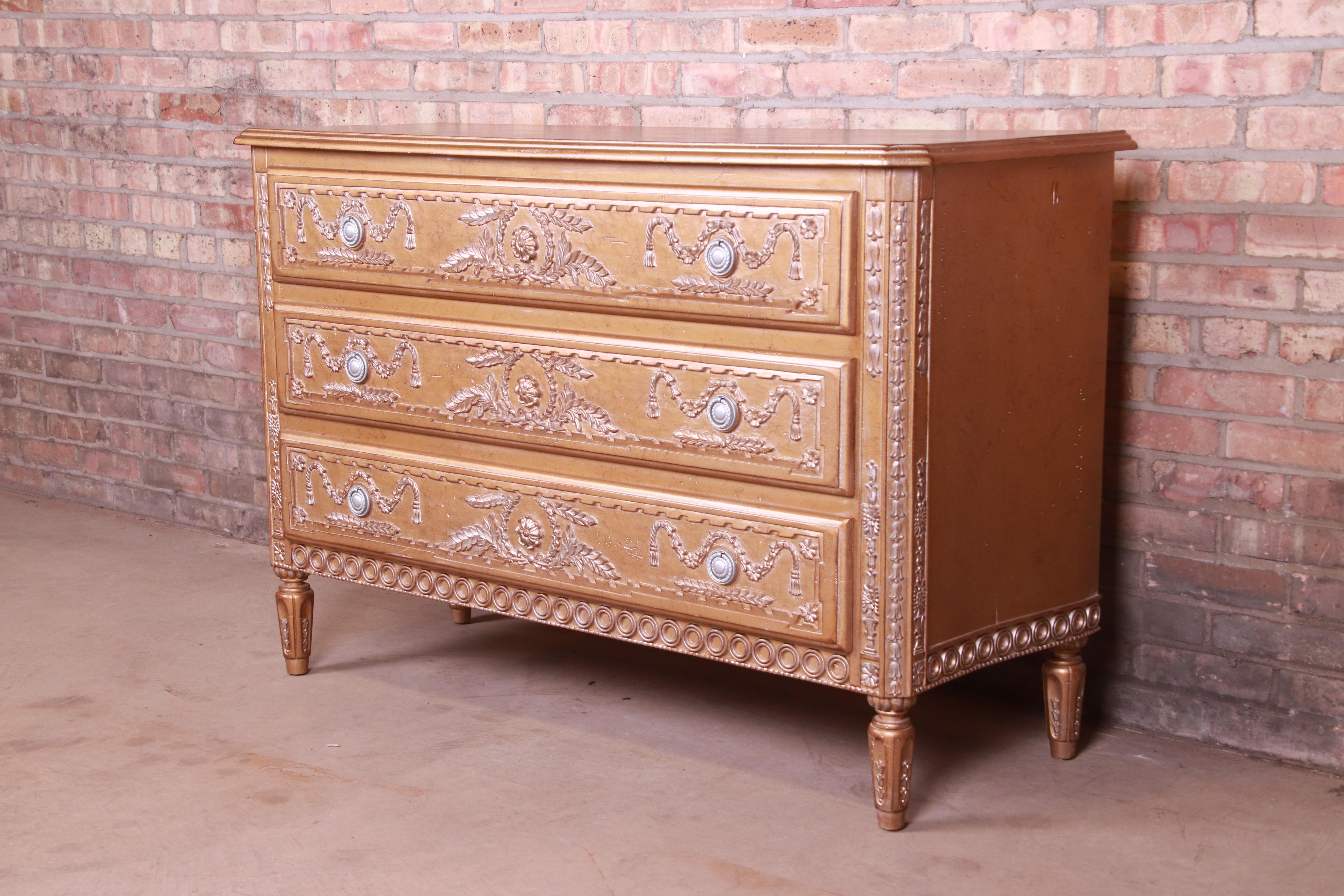 A gorgeous French Regency Louis XVI style chest of drawers or commode

20th century

Ornate carved gold giltwood, with original hardware.

Measures: 51.75