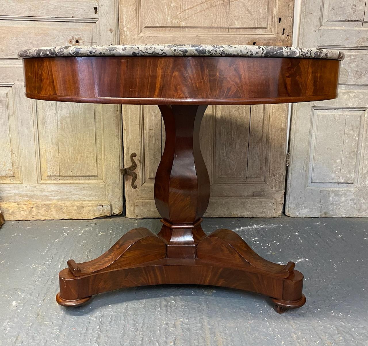 A stunning French Gueridon Marble Top Centre Table, having a fantastic original grey variegated Marble top which has an inset groove. Lovely flame Mahogany Base and it dates to the Regency period. We have re finished it to a very high standard so in