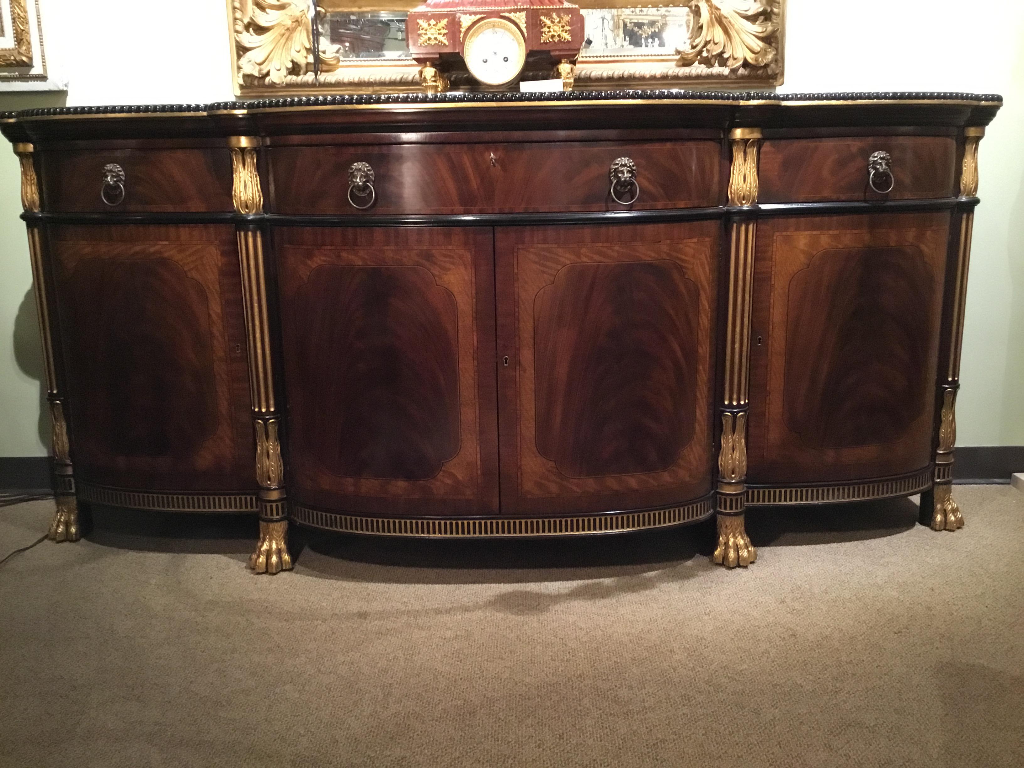 French Regency style reproduction of an 18th century. Style. Mahogany with giltwood accents.
Fine crotch mahogany with superb carving and excellent detail throughout. The piece is
beautifully curved in a serpentine fashion in the front. A