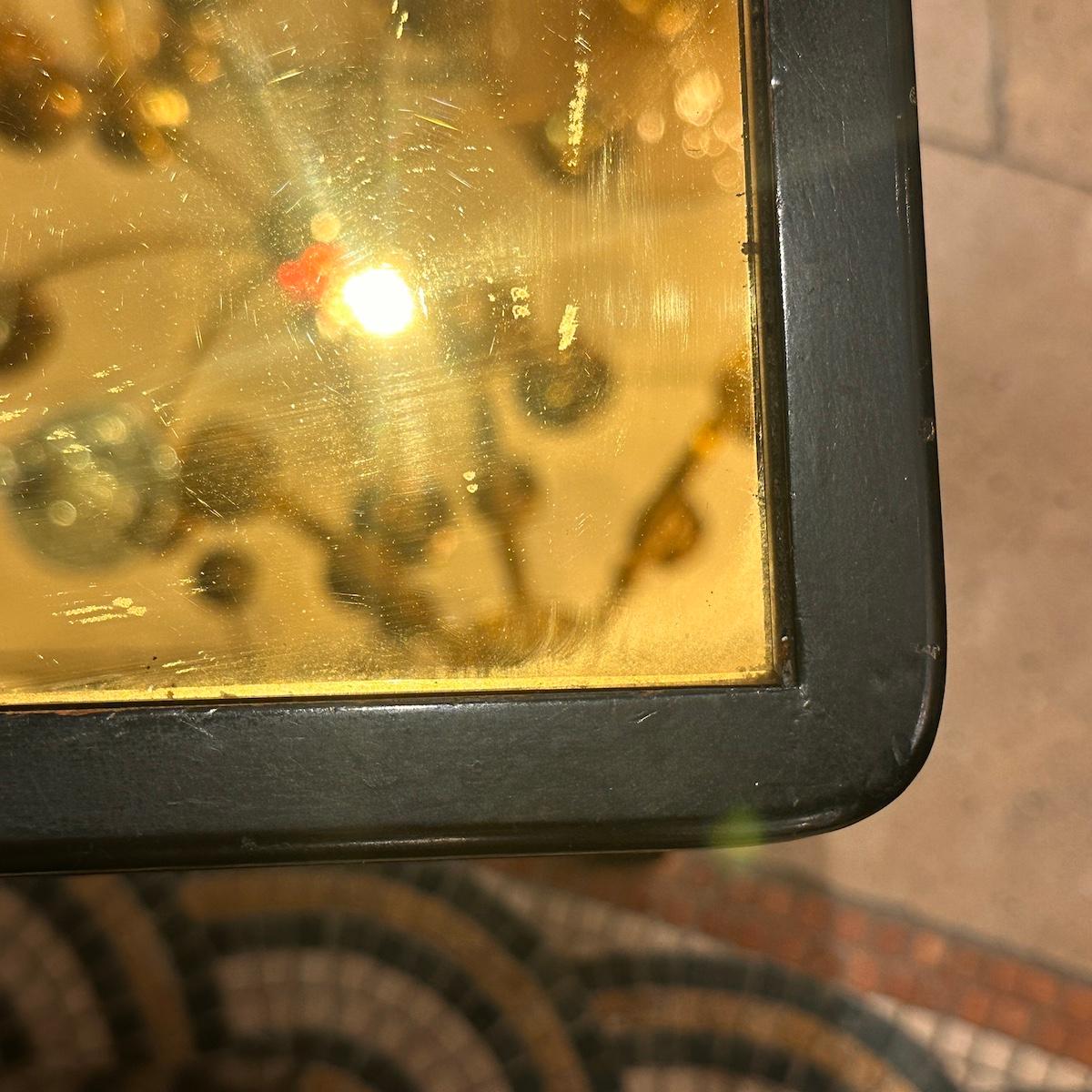 A French circa 1940's yellow mirror top coffee table in the Regency style.

Measurements:
Height: 18.25