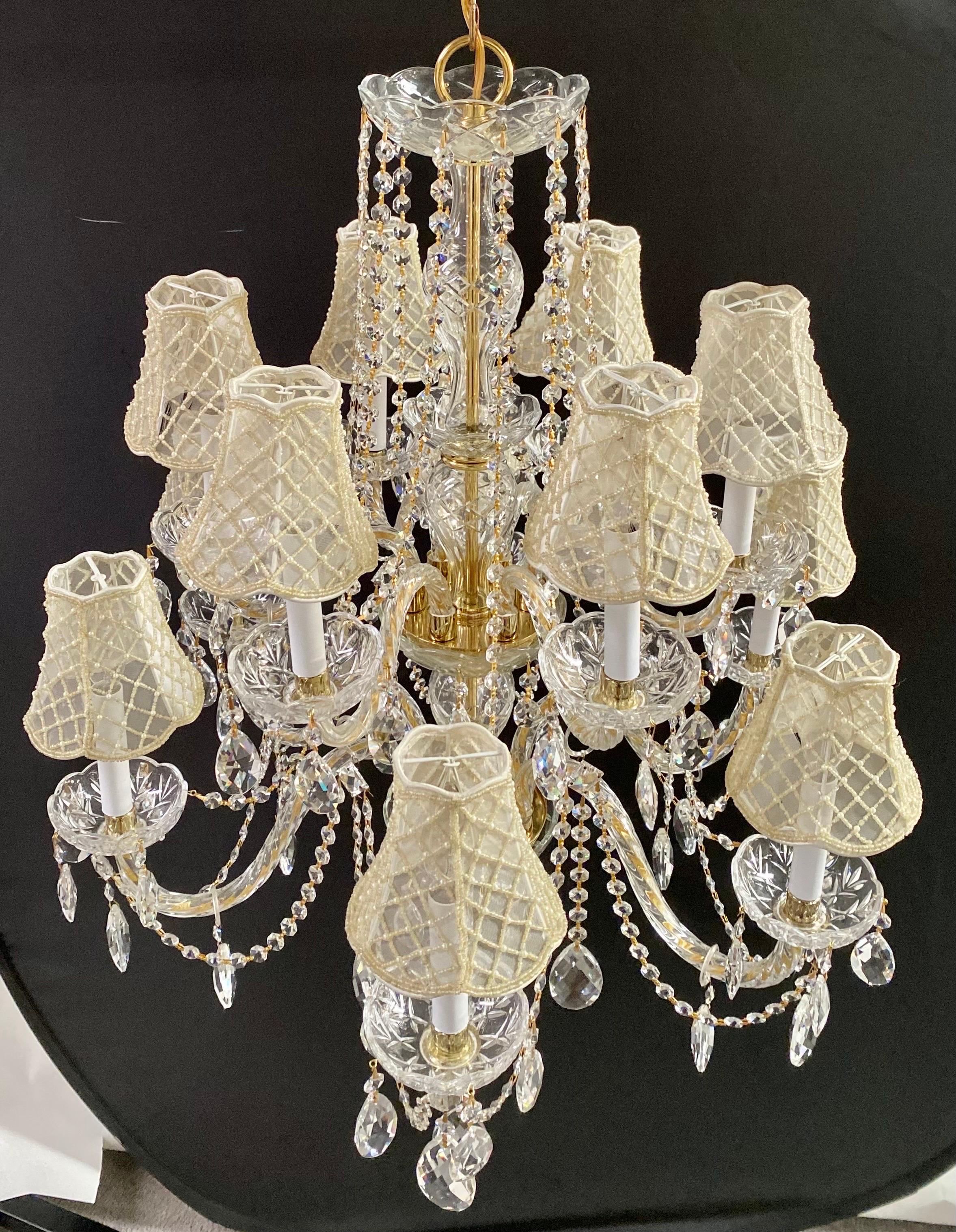 In the grand tradition of French Regency aesthetics, the resplendent crystal chandelier emerges as a quintessential embodiment of opulence and refinement. Adorned with twelve gracefully sinuous glass arms, this magnificent fixture stands as a