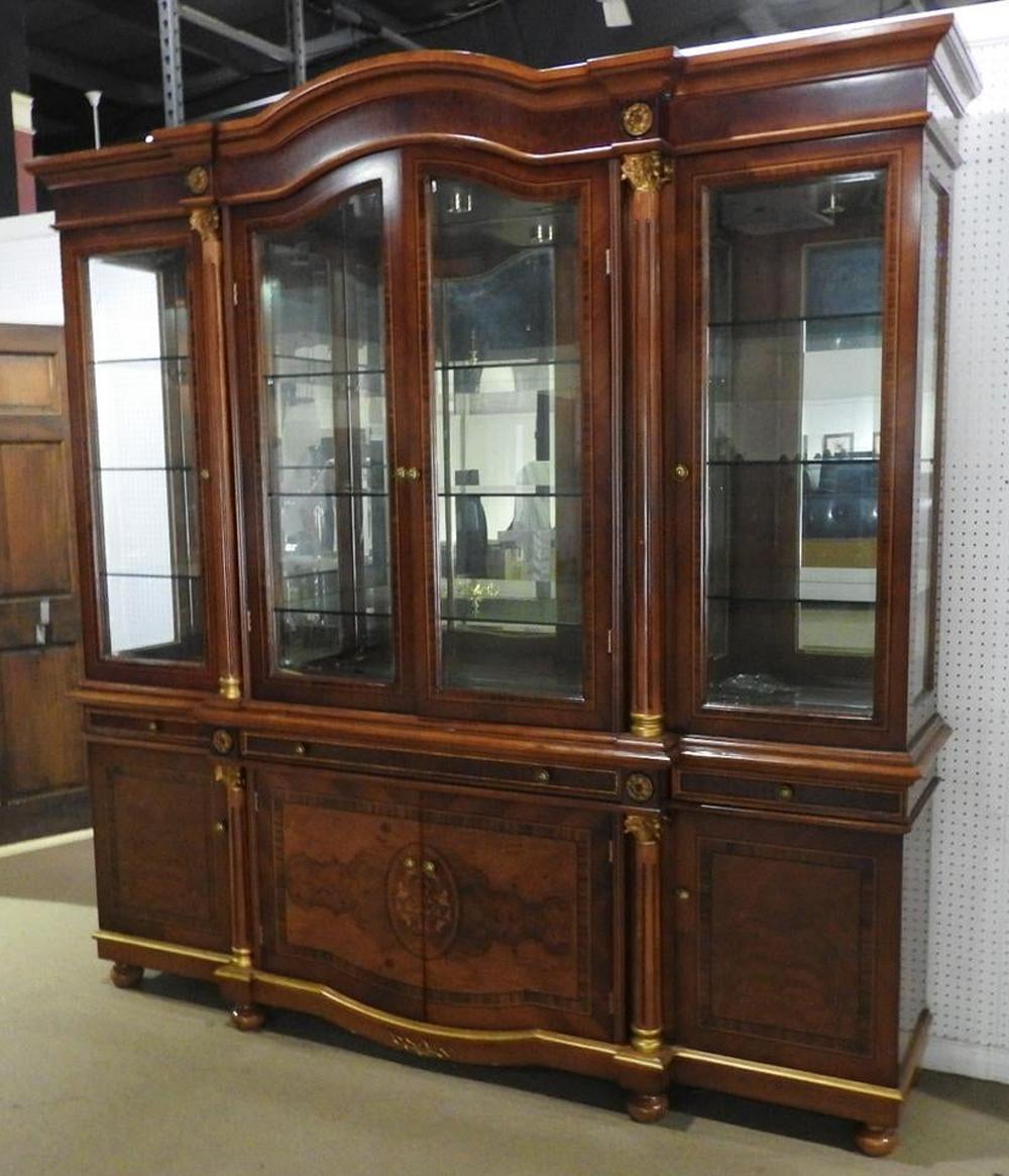 Many know the name Savafvieh. They are dealers and makers of some of the best French Regency pieces today. This beautiful breakfront has a rich and luxurious look and couldn't be better suited for royalty. The top contains 4 glass doors each having