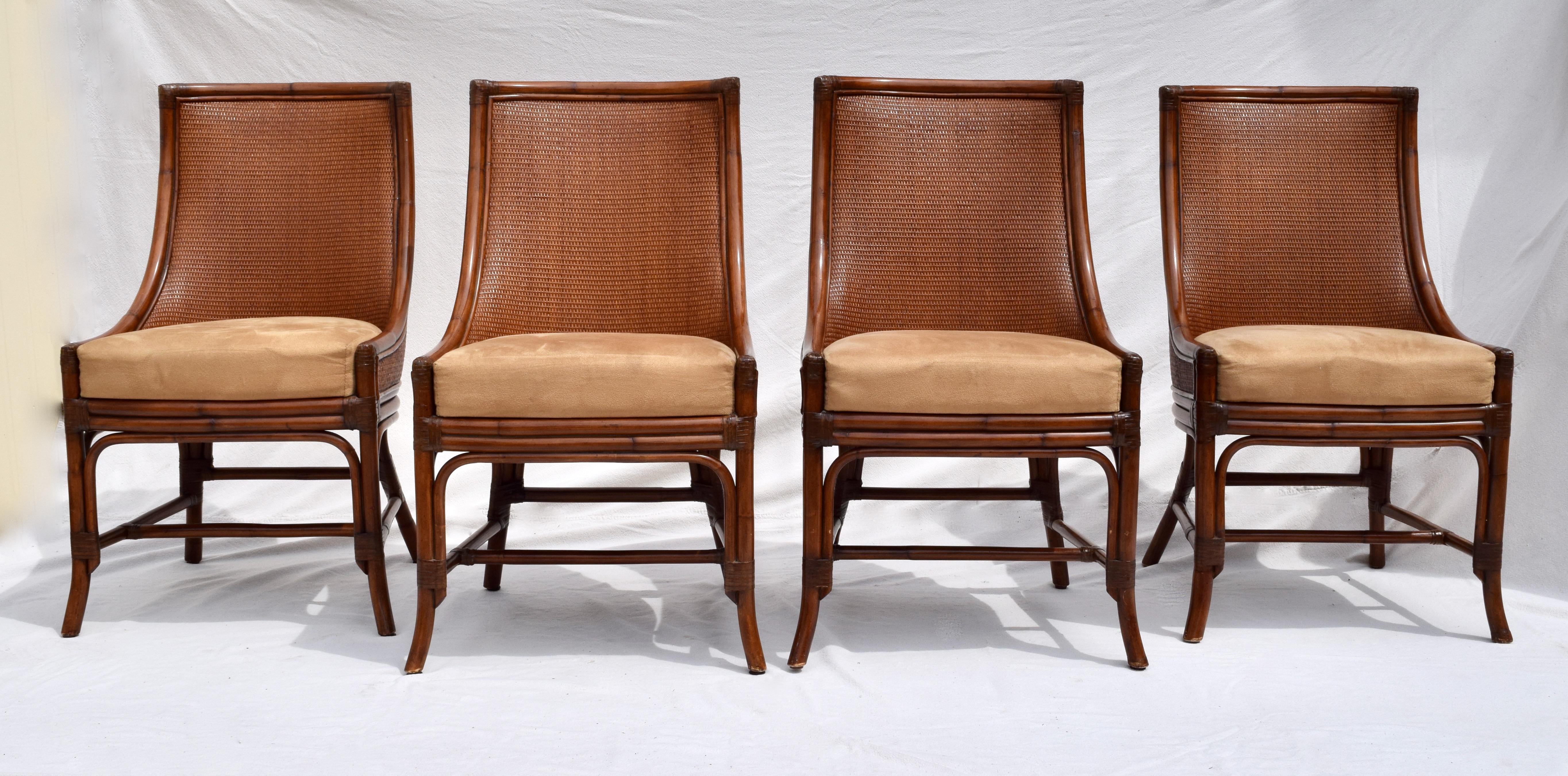 A set of four Regency style faux bamboo dining chairs in excellent vintage condition featuring plushly lined grasscloth surround inside & out upholstered in Palomino faux leather suede with leather joinery. Palecek tags are in tact. Measure: Seat